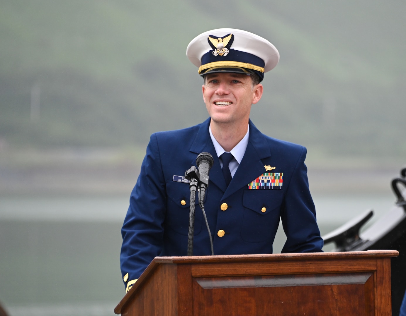 U.S. Coast Guard Lt. Cdr. James Toohey, commanding officer, Cypress, addresses Cypress personnel and audience members during a change-of-command ceremony at Base Kodiak, Aug. 3, 2023. Toohey reported to Cypress from the Shore Infrastructure Logistics Center in Norfolk, Virginia, where he served as the Depot Level Maintenance Program Manager. U.S. Coast Guard photo by Petty Officer 3rd Class Ian Gray.
