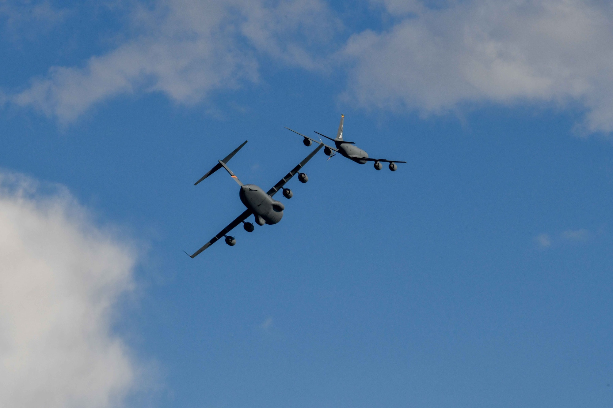 A C-17 Globemaster III and KC-135 Stratotanker from Altus Air Force Base (AFB), Oklahoma perform a flyover at the 2023 Experimental Aviation Association AirVenture Air Show in Oshkosh, Wisconsin, July 29, 2023. Altus AFB deployed the KC-135 and C-17 demo team to showcase the capabilities of each aircraft. (U.S. Air Force photo by Airman 1st Class Karalyn Degraffenreed)