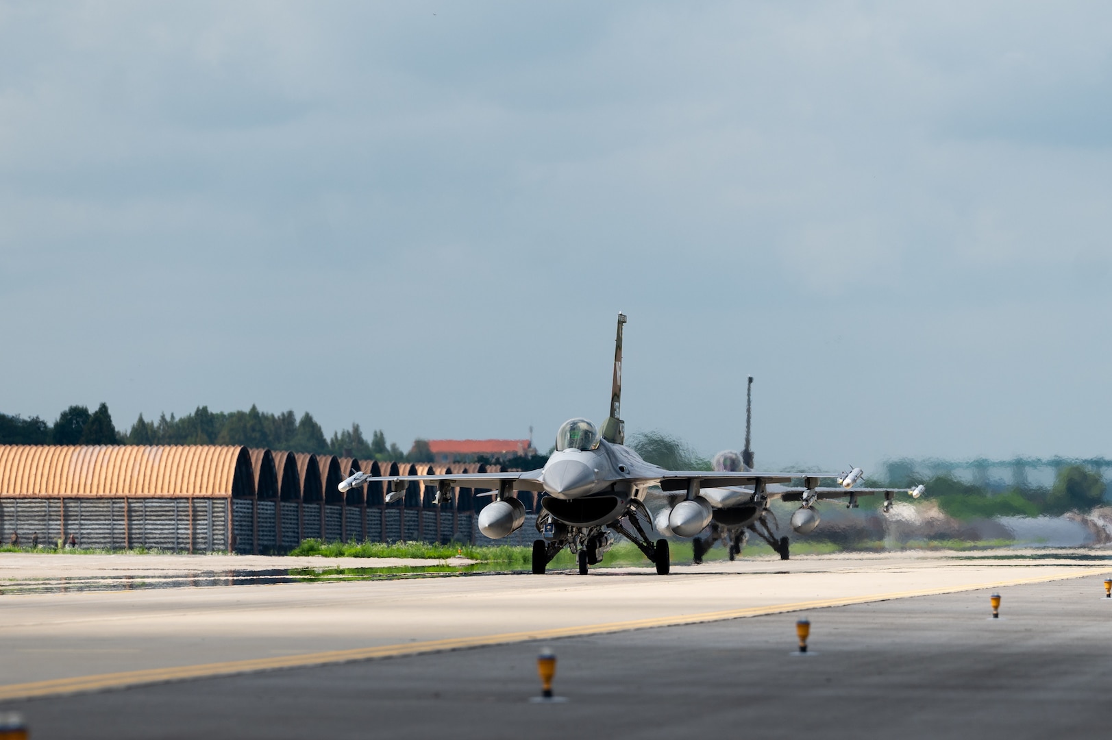 Two F-16 Fighting Falcons assigned to the 35th Fighter Squadron taxi to the runway before taking off
