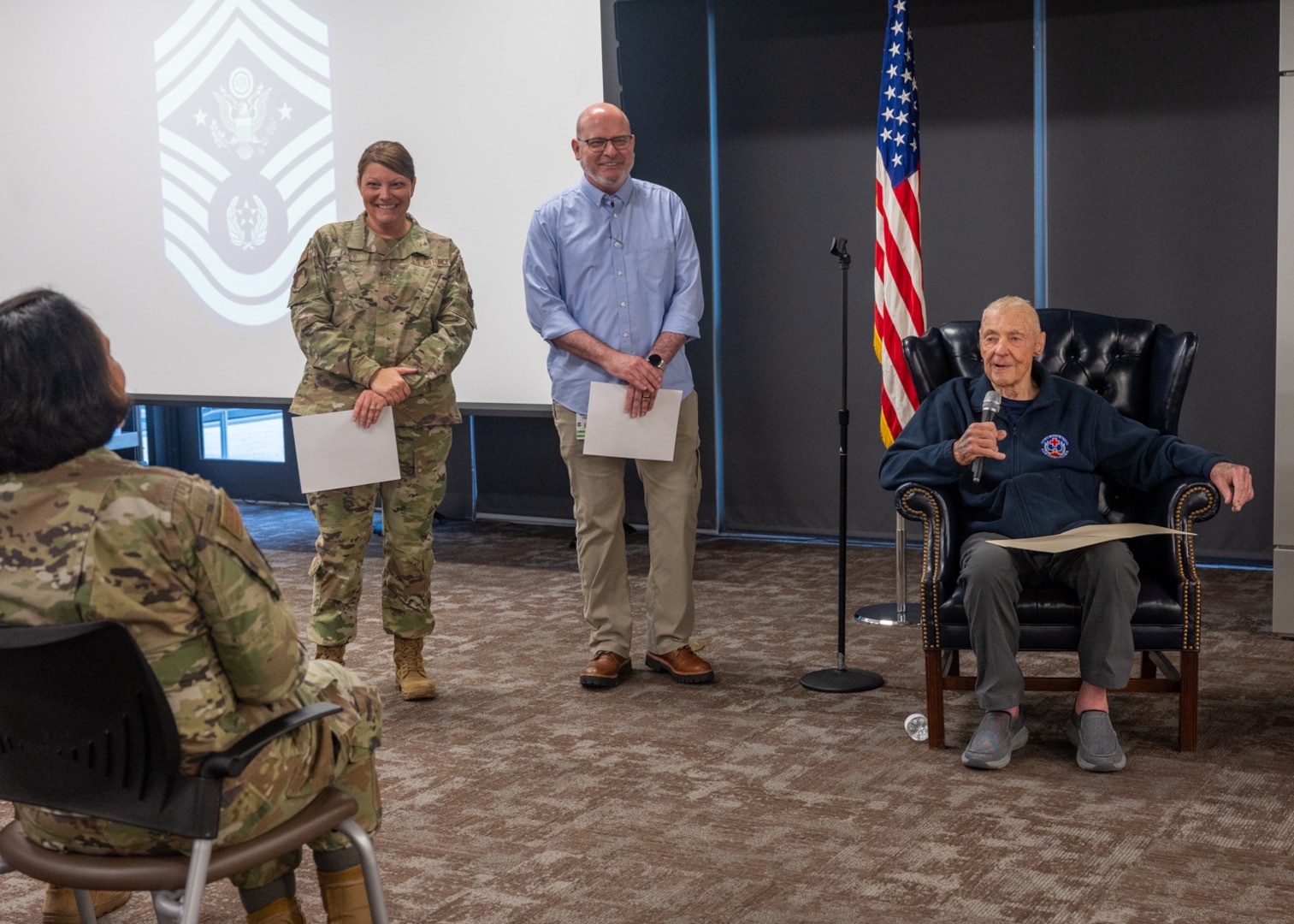 Chief Master Sergeant of the Air Force #5 (ret.) Robert Gaylor presents Chief Master Sgt. Kristy Earls, 59th Medical Wing command chief (left), and Cody Kirksey, 59th MDW protocol chief (middle), with a memo he wrote, Bob Gaylor’s 25 Words, at Wilford Hall Ambulatory Surgical Center, Joint Base San Antonio-Lackland, Texas, Aug. 2, 2023. Gaylor became Chief Master Sergeant of the Air Force on Aug. 1, 1977 and retired July 31, 1979. (U.S. Air Force photo by Senior Airman Melody Bordeaux)
