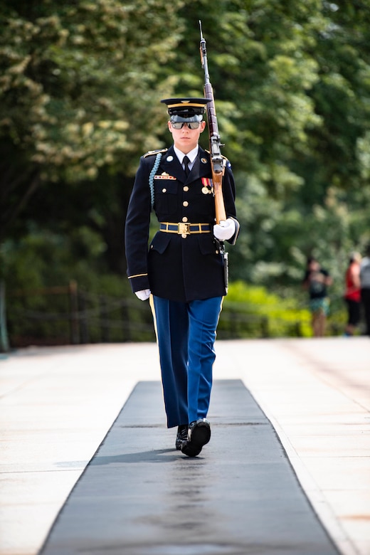 A soldier holding a rifle walks the mat at the Tomb of the Unknown Soldier.