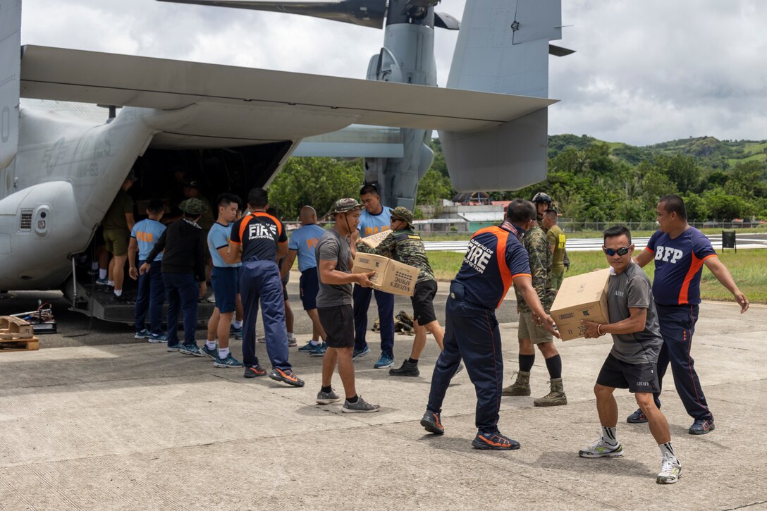 Philippine Marines, Soldiers, Fire Fighters, and Policemen offload food and water, provided by the Government of the Philippines, from a U.S. Marine Corps MV-22B Osprey with Marine Medium Tiltrotor Squadron (VMM) 163 (Reinforced), Marine Aircraft Group 16, 3rd Marine Aircraft Wing while conducting relief efforts in the wake of Typhoon Egay, international name Typhoon Doksuri, in Basco, Batanes province, Philippines, Aug. 1, 2023. At the request of the Armed Forces of the Philippines, U.S. Marines are providing relief and lifesaving capabilities to remote regions of the Philippines. The forward presence and ready posture of I Marine Expeditionary Force assets in the region facilitated rapid and effective response to crisis, demonstrating U.S. commitment to Allies and partners. During the first two days of relief efforts, VMM-163 (Rein.) delivered approximately 25,600 pounds of food and water, provided by the Government of the Philippines, to remote, affected communities. (U.S. Marine Corps photo by Sgt. Sean Potter)