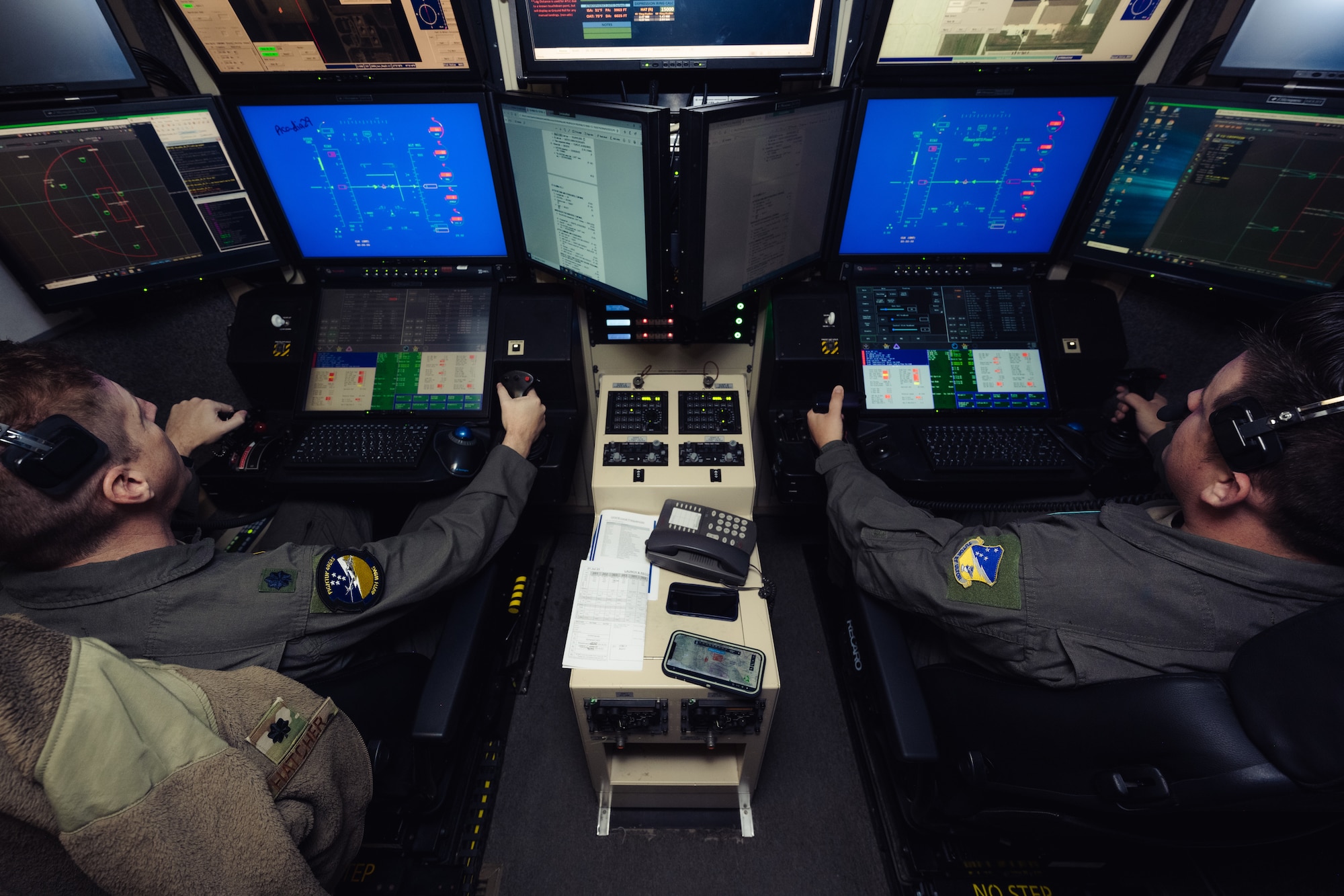 U.S. Air Force Lt. Col. Nicholas Hatcher, 49th Wing chief of safety, left, and U.S. Air Force Staff Sgt. Austin Shuta, 29th Attack Squadron instructor sensor operator, prepare to launch an MQ-9 Reaper during Agile Combat Employment Grand Warrior at Holloman Air Force Base, New Mexico, July 21, 2023. his exercise marks the first time the 49th Wing performed an entire mission under complete Satellite Communication control operated solely by Mission Control Element personnel the entire time in unfamiliar airspace.  (U.S. Air Force photo by Senior Airman Antonio Salfran)