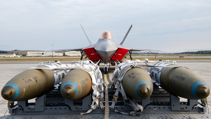 A U.S. Air Force F-22 Raptor assigned to the 3rd Wing waits behind dummy bombs during a load competition at JBER, July 28, 2023