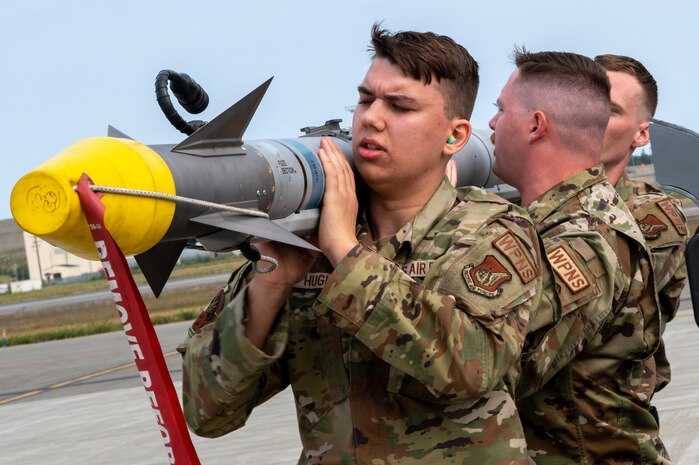 Weapons load crew assigned to the 356th Fighter Generation Squadron, Eielson, AFB, load training missile during load competition at JBER, July 28, 2023