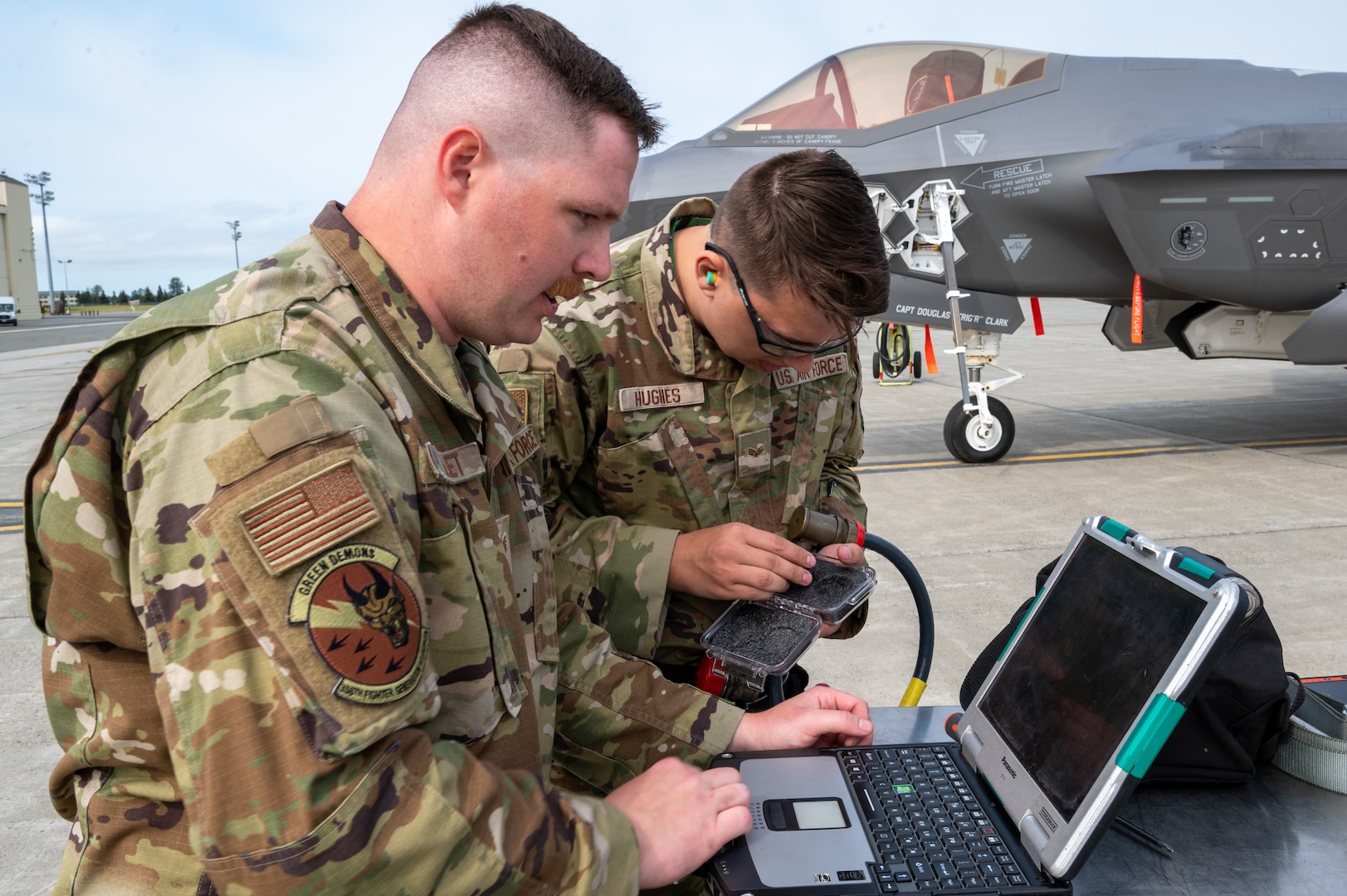 Weapons load crew members assigned to the 356th Fighter Generation Squadron, Eielson AFB, examine equipment during a load competition at JBER, July 28, 2023