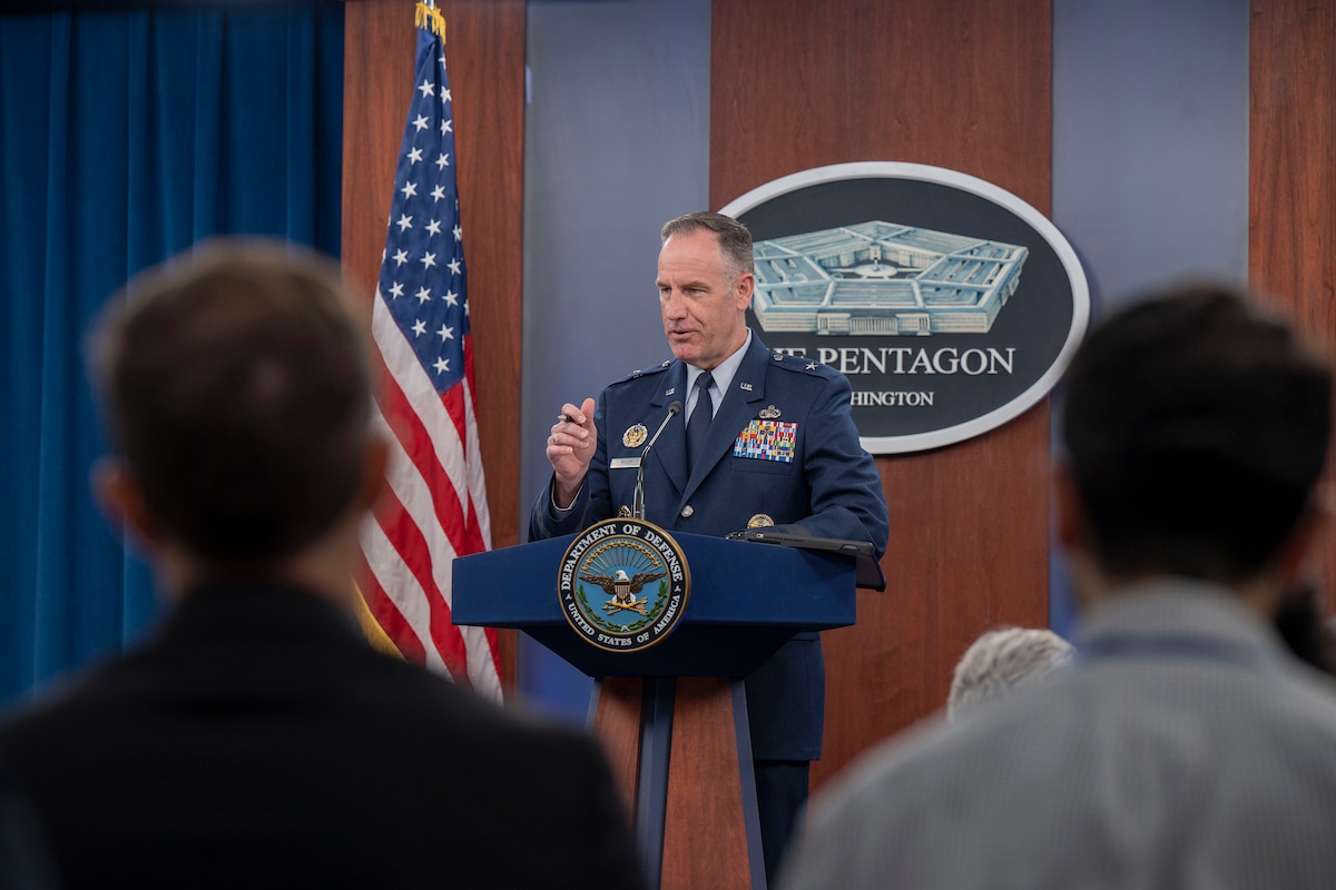 An Air Force general in uniform stands behind a lectern.