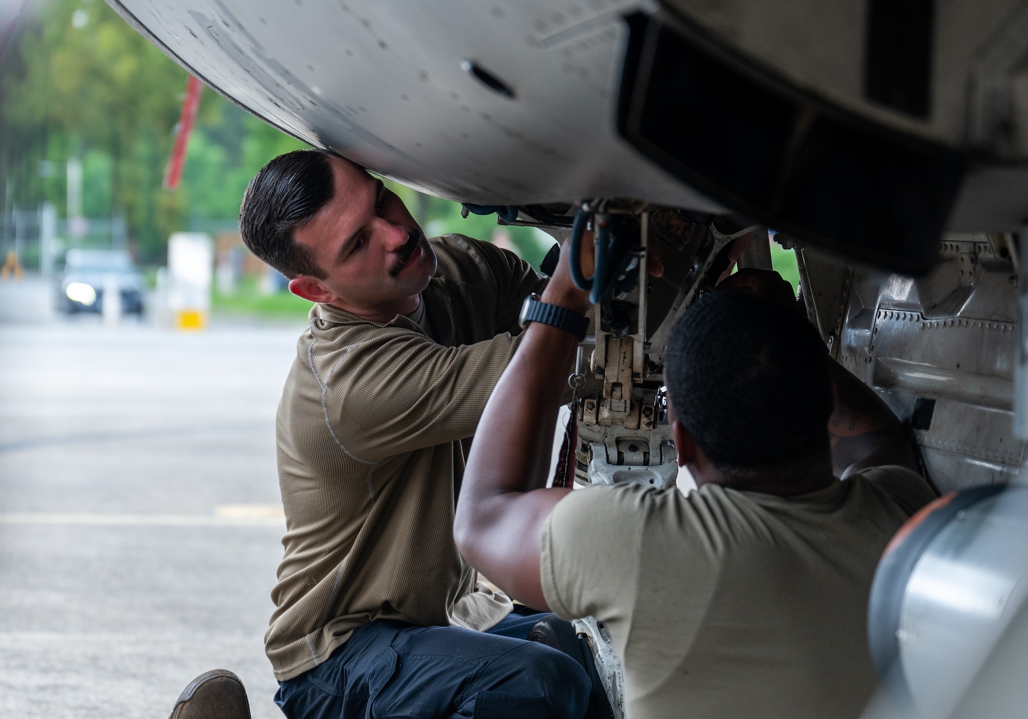 35th Fighter Generation Squadron dedicated crew chief, and aircraft electrical environmental systems technician, perform initial checks of the landing equipment on an F-16 Fighting Falcon