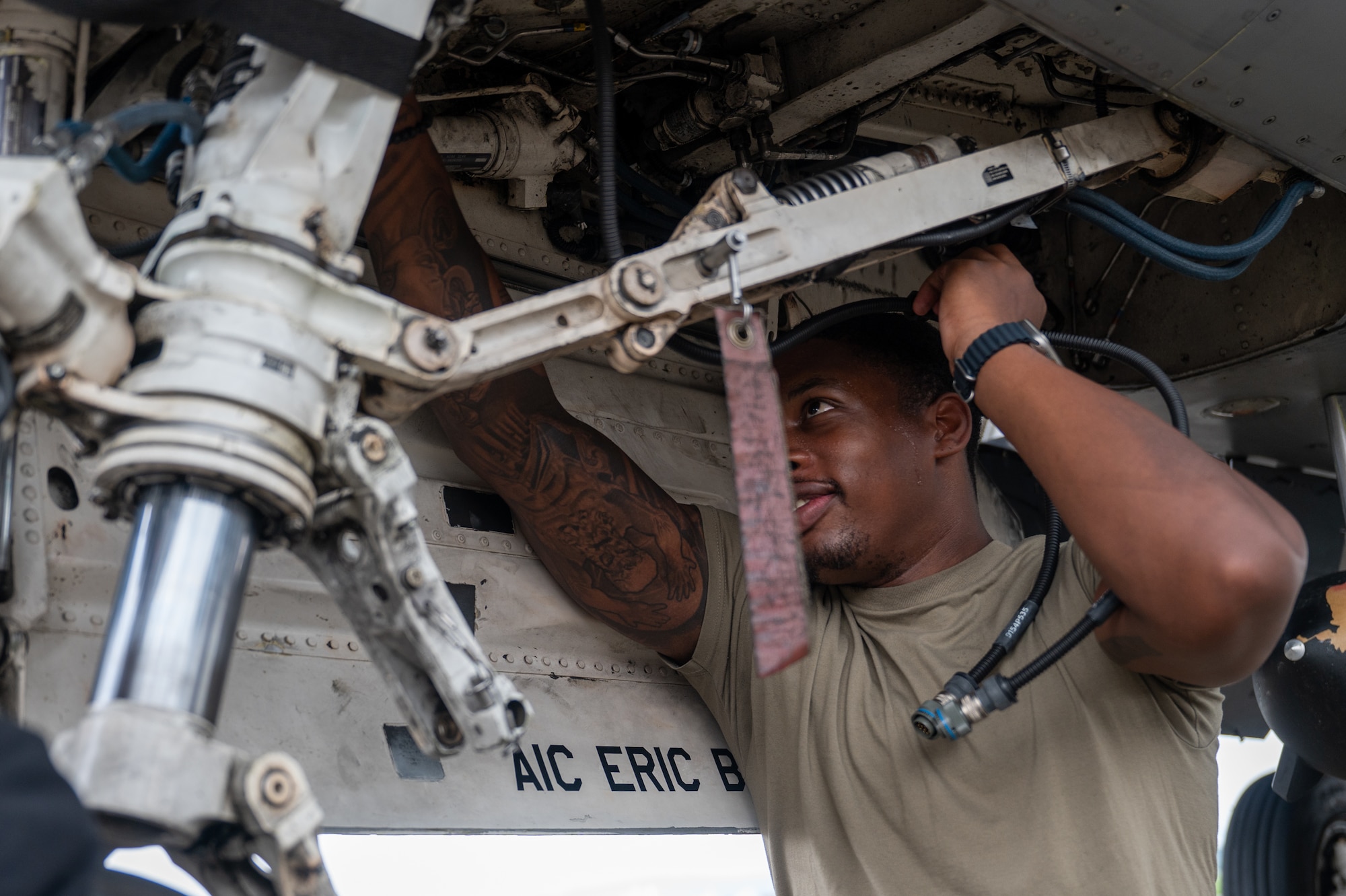 35th Fighter Generation Squadron aircraft electrical environmental systems technician, inspects the landing equipment of an F-16 Fighting Falcon