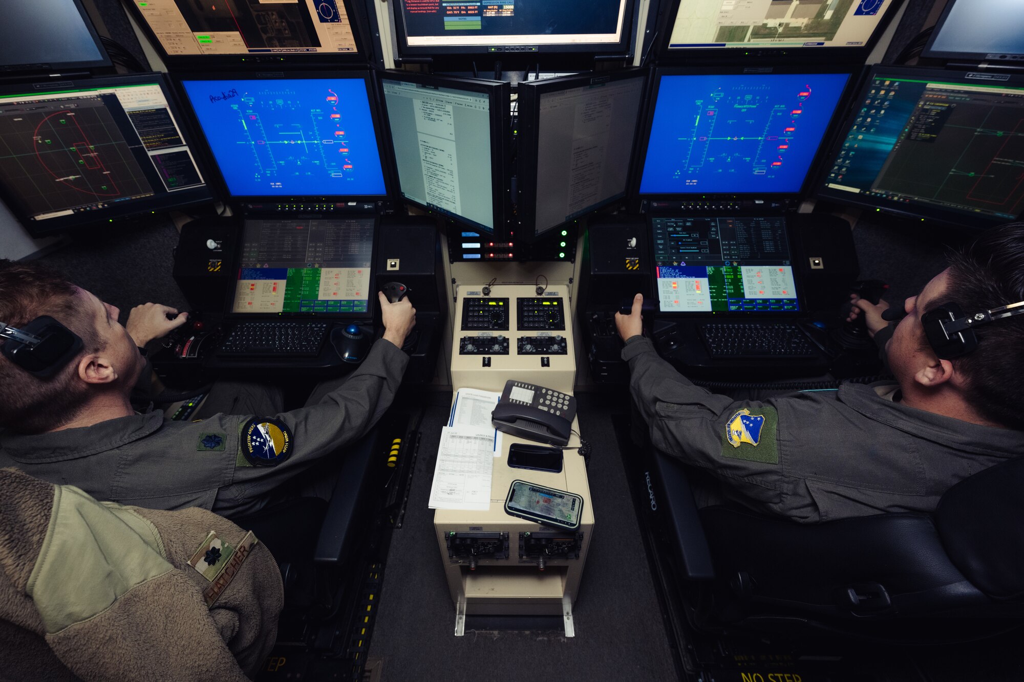 U.S. Air Force Lt. Col. Nicholas Hatcher, 49th Wing chief of safety, left, and U.S. Air Force Staff Sgt. Austin Shuta, 29th Attack Squadron instructor sensor operator, prepare to launch an MQ-9 Reaper during Agile Combat Employment Grand Warrior at Holloman Air Force Base, New Mexico, July 21, 2023. his exercise marks the first time the 49th Wing performed an entire mission under complete Satellite Communication control operated solely by Mission Control Element personnel the entire time in unfamiliar airspace.  (U.S. Air Force photo by Senior Airman Antonio Salfran)