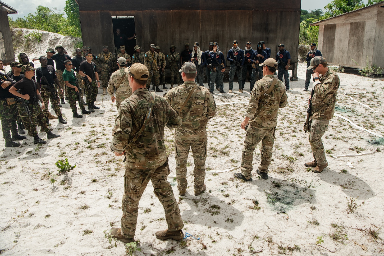 U.S. military forces demonstrate close quarters battle tactics to multinational military members