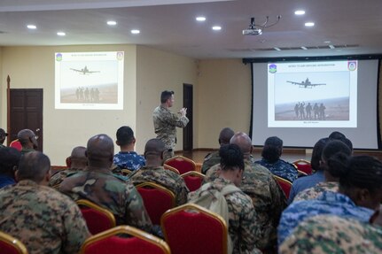 A U.S. Airman briefs multinational forces about air ground integration