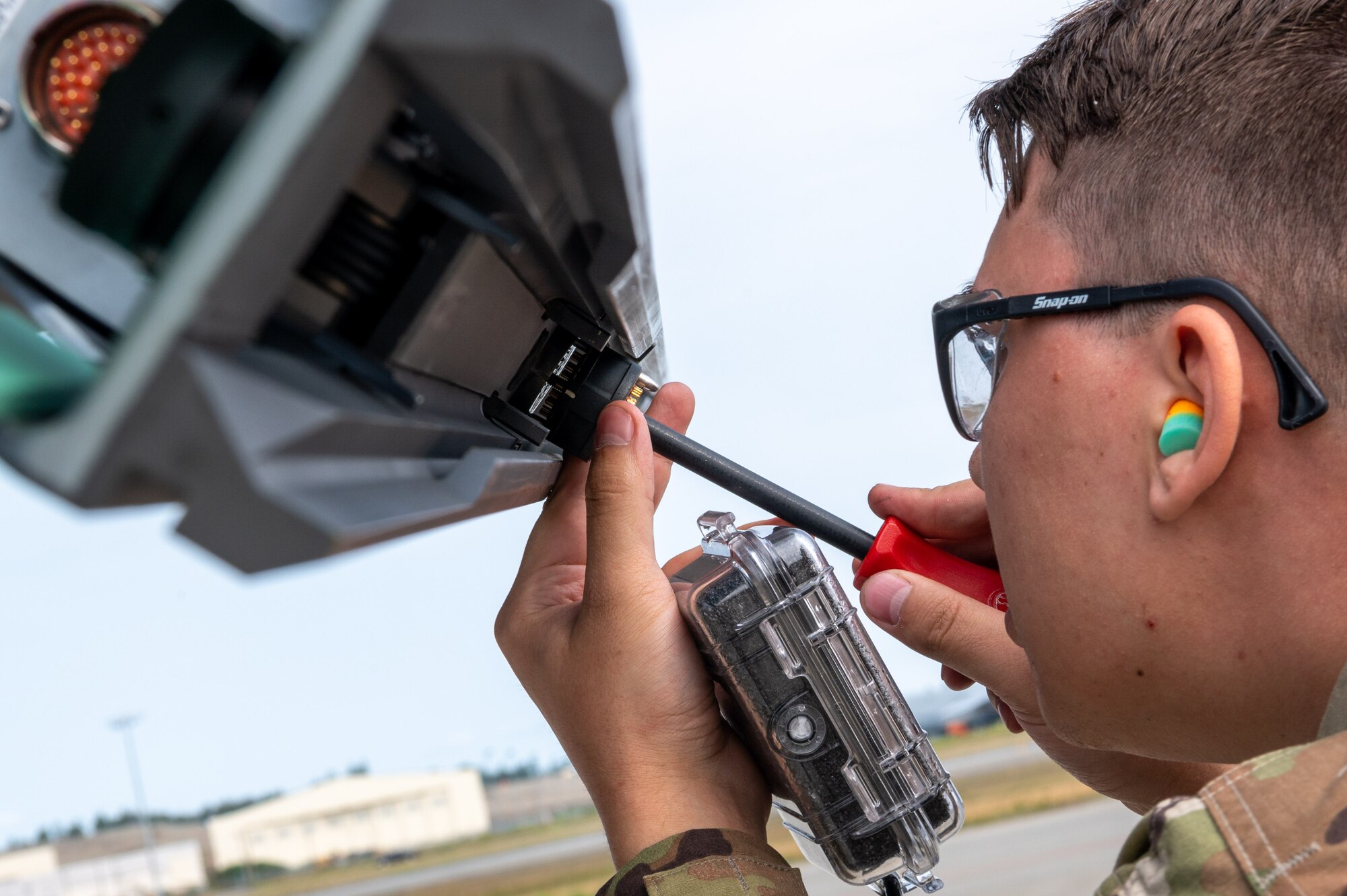 SrA Hughes, weapons load crew member assigned to the 356th Fighter Generation Squadron, Eielson AFB, makes adjustments during a load competition at JBER, July 28, 2023