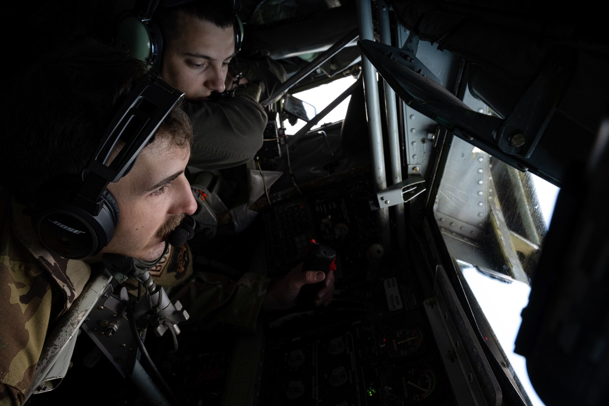 U.S. Air Force Airman 1st Class Shane Silver, left, and Airman 1st Class David Trulson, 93rd Expeditionary Air Refueling Squadron boom operators, watch an aerial refueling over the North Sea