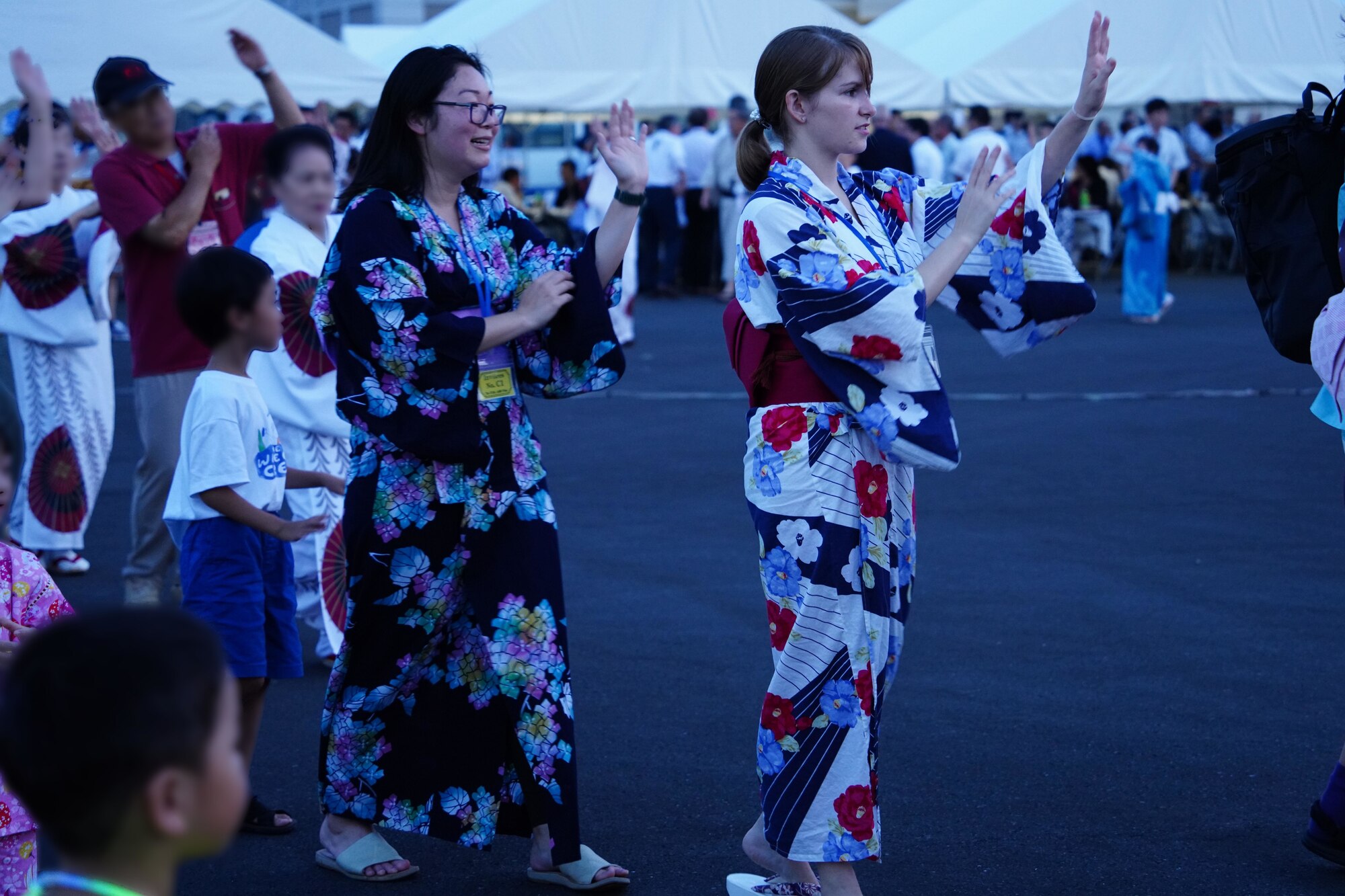 People perform Japanese Bon Odori during a bon dance festival at Fuchu Air Base