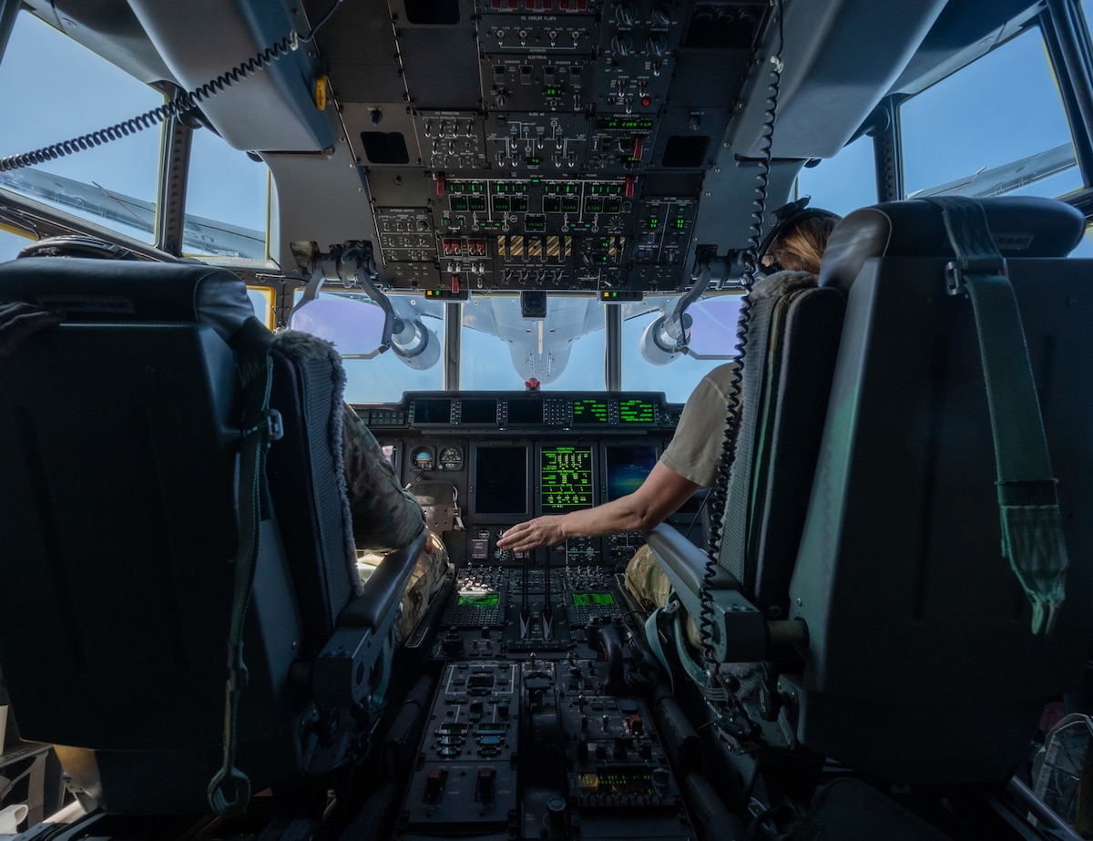 Maj. Carl Price and Capt. Elisabeth Holloway, 39th Rescue Squadron pilots, fly an HC-130J Combat King II
