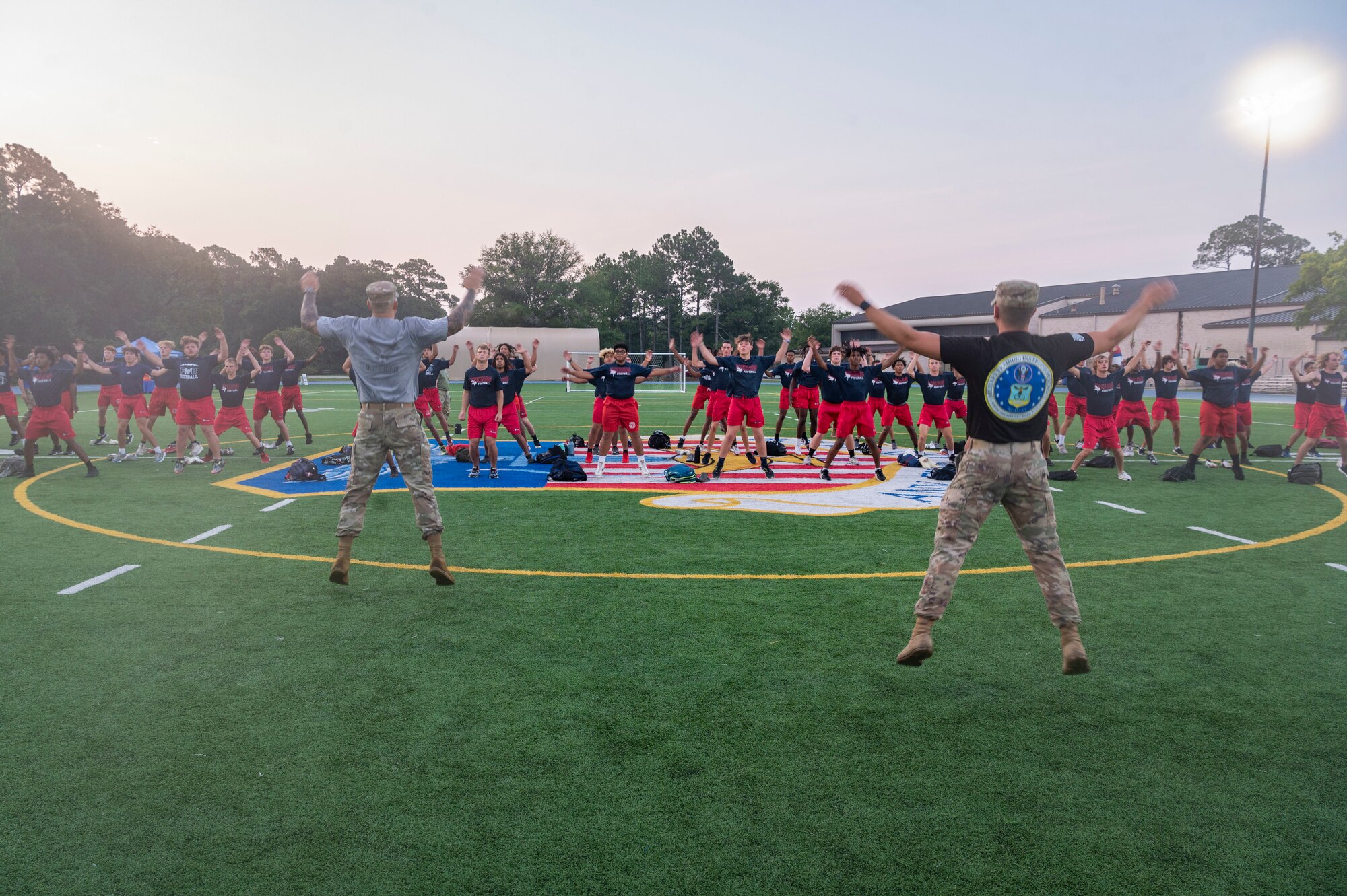 Members of the Fort Walton Beach High School Vikings football team go through a Basic Military Training-style exercise session during Air Commando Youth Athletic Camp at Hurlburt Field, Florida, July 19, 2023.