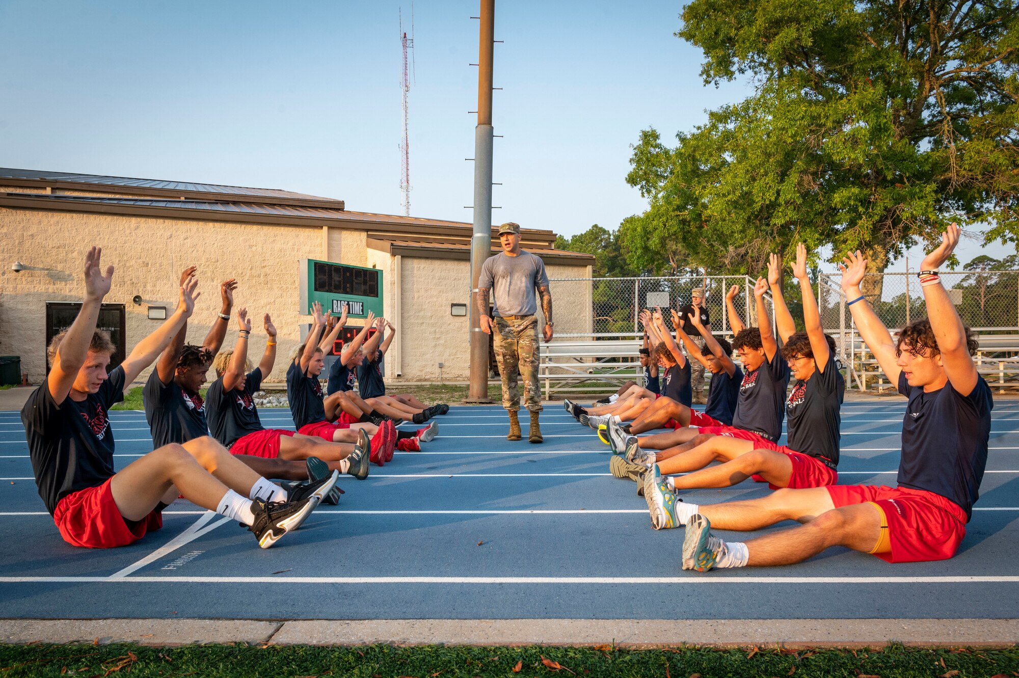Members of the Fort Walton Beach High School Vikings football team go through a Basic Military Training-style exercise session during Air Commando Youth Athletic Camp at Hurlburt Field, Florida, July 19, 2023.