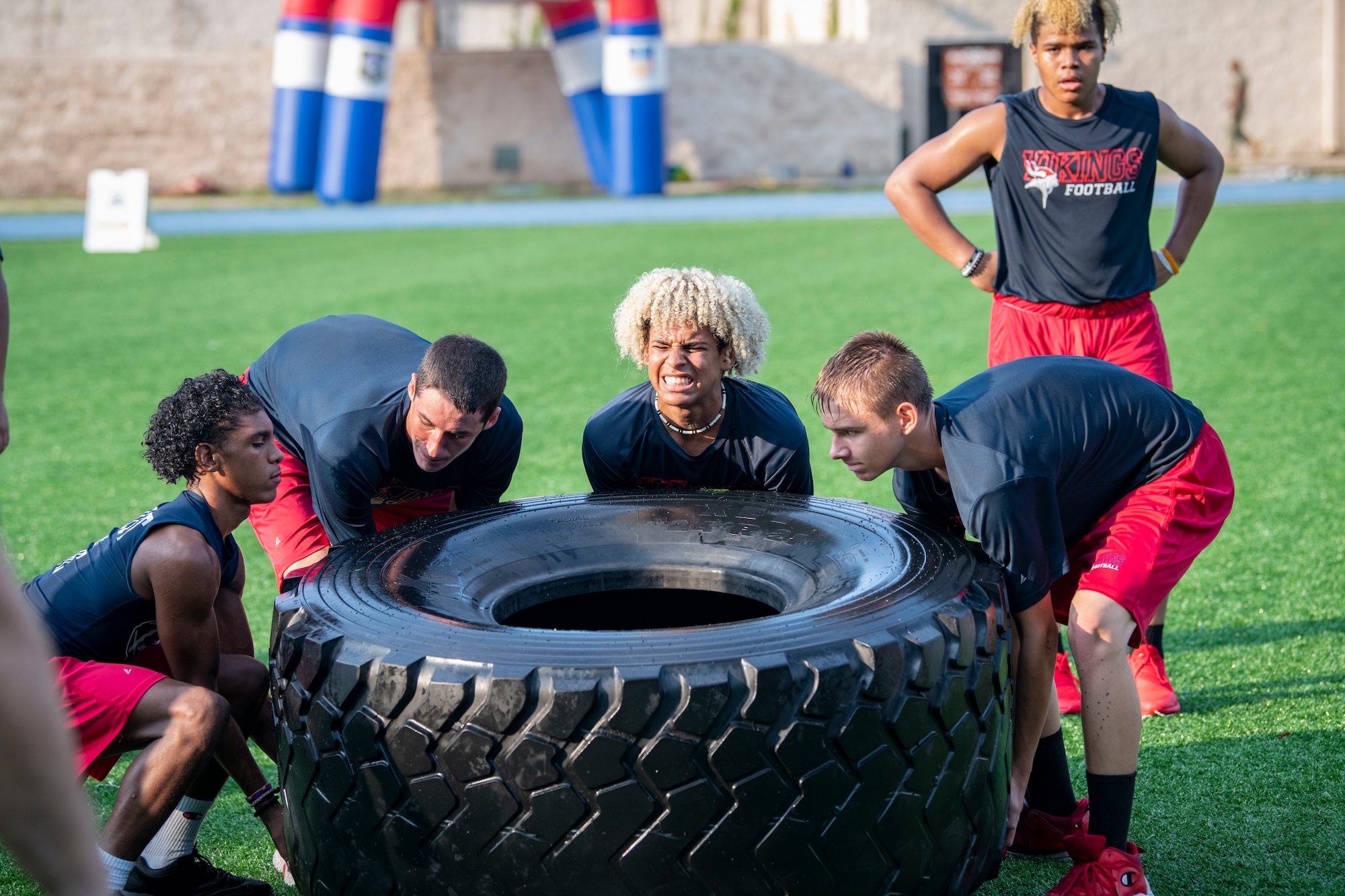 Members of the Fort Walton Beach High School Vikings football team go through a Basic Military Training-style exercise session during Air Commando Youth Athletic Camp at Hurlburt Field, Florida, July 19, 2023.