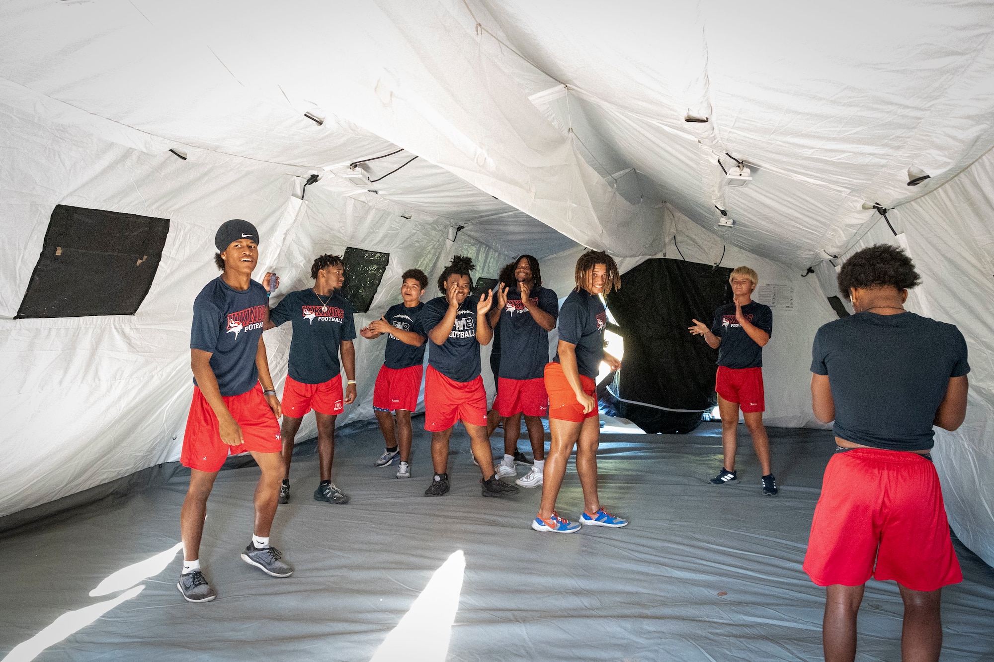 Members of the Fort Walton Beach High School Vikings football team celebrate winning the military tent building competition during Air Commando Youth Athletic Camp at Hurlburt Field, Florida, Aug. 2, 2023.