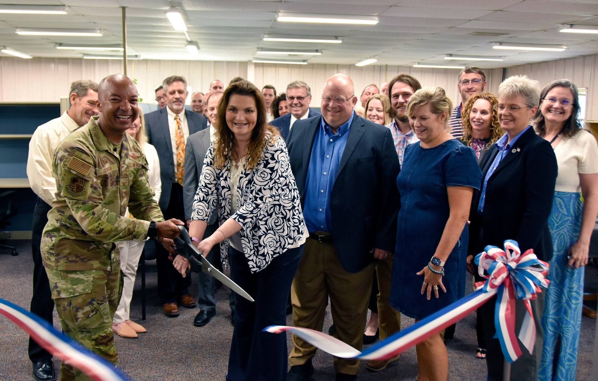 Col. Randel Gordon, Arnold Engineering Development Complex commander, left, and Kellee Pritt, AEDC Program Management director, center, cut the ribbon on the new Acquisition Branch office, part of the Program Management Office, July 13, 2023, at Arnold Air Force Base, Tenn., while AEDC leadership and Program Management Office personnel look on. The Acquisition Branch will be tasked with leading the revitalization, development, delivery and installation of programs within the ground test capabilities across AEDC, and ensuring key program milestones are met within cost, schedule and performance requirements while adhering to quality, safety and technical standards to meet the demands of the National Defense Strategy. The goal of the Acquisition Branch team is to increase test capabilities throughout AEDC to help the U.S. Air Force remain competitive with near-peer adversaries. (U.S. Air Force photo by Bradley Hicks)