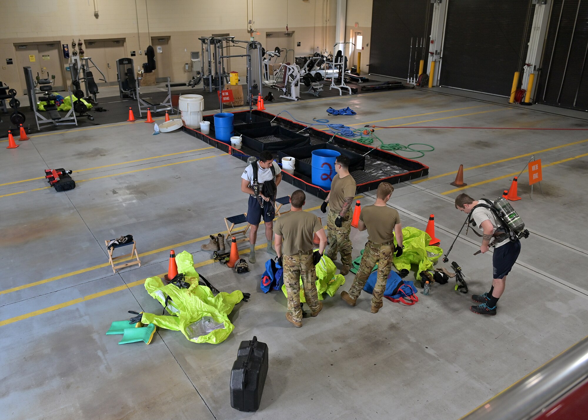 Firefighters begin preparations to respond to a simulated hazardous materials spill.