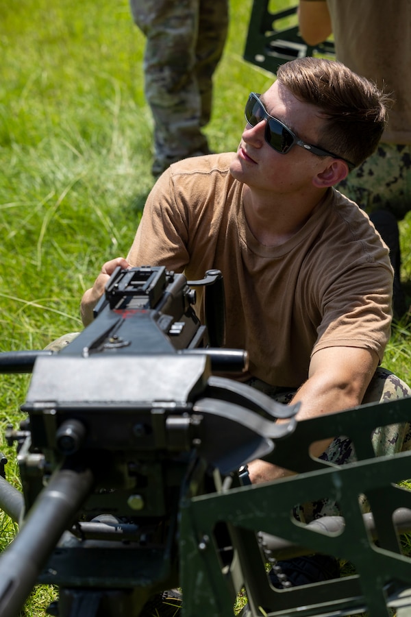 Midshipman 1st Class Samuel Murray, a Bay Village, Ohio, native and senior at the U.S. Naval Academy, practices weapon clearing techniques during a Mark 19 40 mm grenade machine gun operations class with Marine Raiders from Marine Forces Special Operations Command on Camp Lejeune, North Carolina, July 26, 2023. While training with MARSOC, the midshipmen were able to experience the variety of tools and weapons employed by critical skills operators and special operations officers. (U.S. Marine Corps photo by Cpl. Henry Rodriguez)