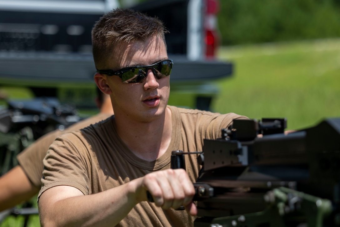 Midshipman 1st Class Charles Longacre, a Prescott, Arizona, native and senior at the U.S. Naval Academy, practices weapon clearing techniques during a Mark 19 40 mm grenade machine gun operations class with Marine Raiders from Marine Forces Special Operations Command on Camp Lejeune, North Carolina, July 26, 2023. While training with MARSOC, the midshipmen were able to experience the variety of tools and weapons employed by critical skills operators and special operations officers. (U.S. Marine Corps photo by Cpl. Henry Rodriguez)