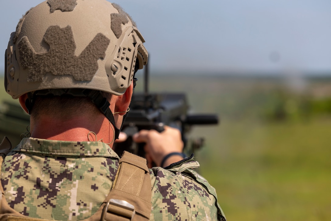Midshipman 3rd Class Brendan McKenna, a Wantagh, New York, native and sophomore at the U.S. Naval Academy, fires a  Mark 19 40 mm grenade machine gun on a live-fire range with Marine Raiders from Marine Forces Special Operations Command on Camp Lejeune, North Carolina, July 26, 2023. While training with MARSOC, the midshipmen were able to experience the variety of tools and weapons employed by critical skills operators and special operations officers. (U.S. Marine Corps photo by Cpl. Henry Rodriguez)