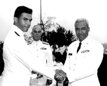 ENS Merle Smith is congratulated by his father after graduating from the Coast Guard Academy.  Smith was the first African American to graduate from CGA.