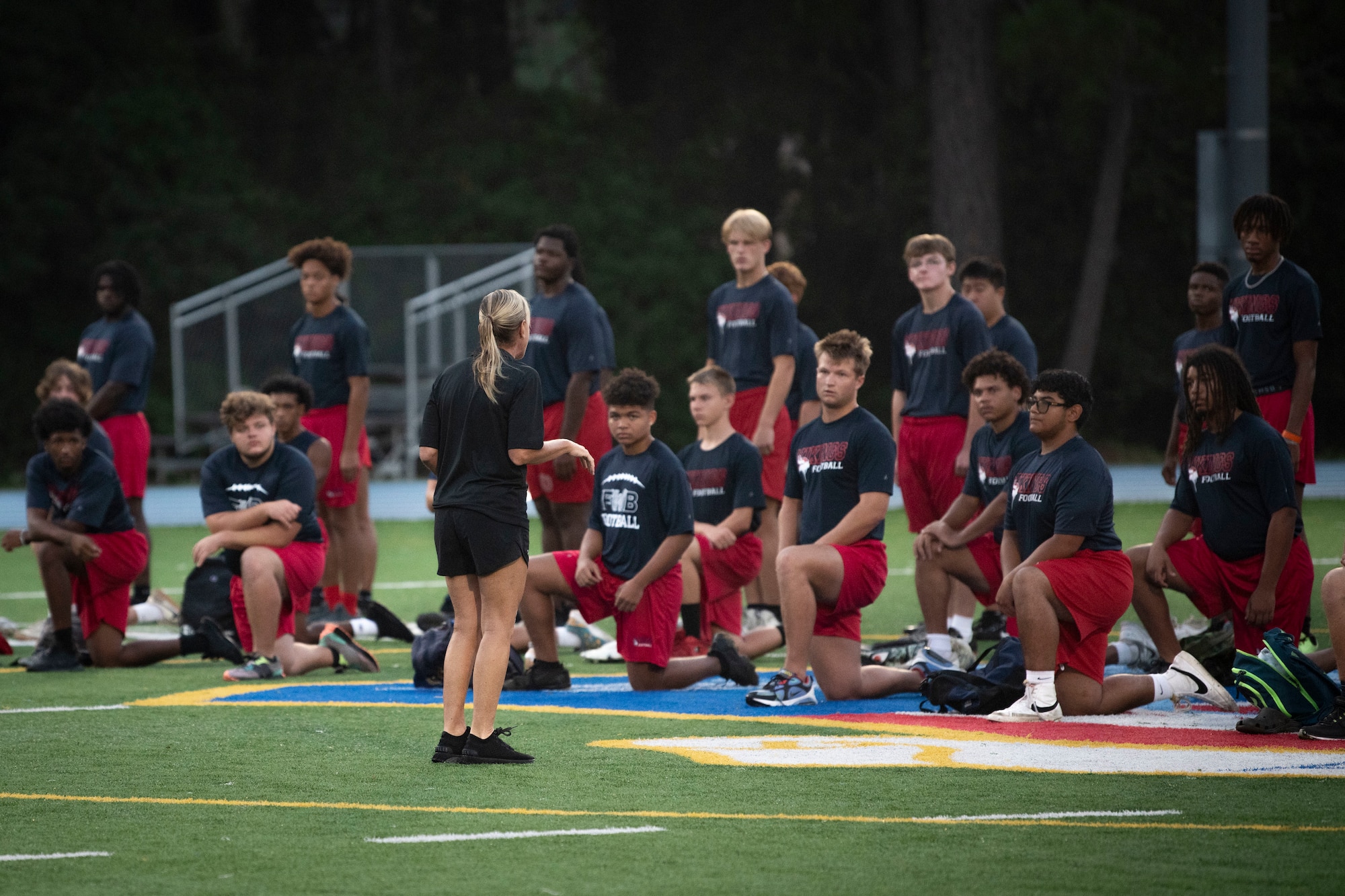 U.S. Air Force Col. Allison Black, 1st Special Operations Wing commander, delivers a speech to the Fort Walton Beach High School Vikings football team before a Basic Military Training-style exercise session during Air Commando Youth Athletic Camp at Hurlburt Field, Florida, July 19, 2023.