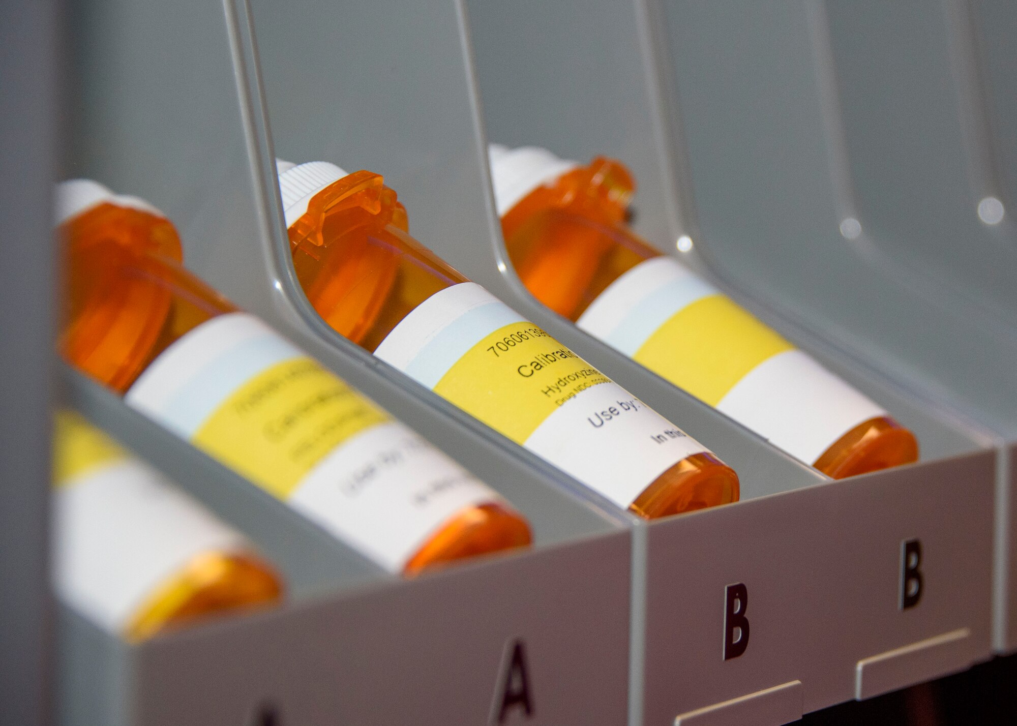 Prescription bottles sit in a machine.