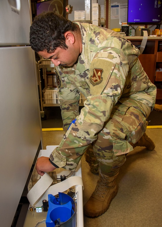 A man in uniform looks at labels.