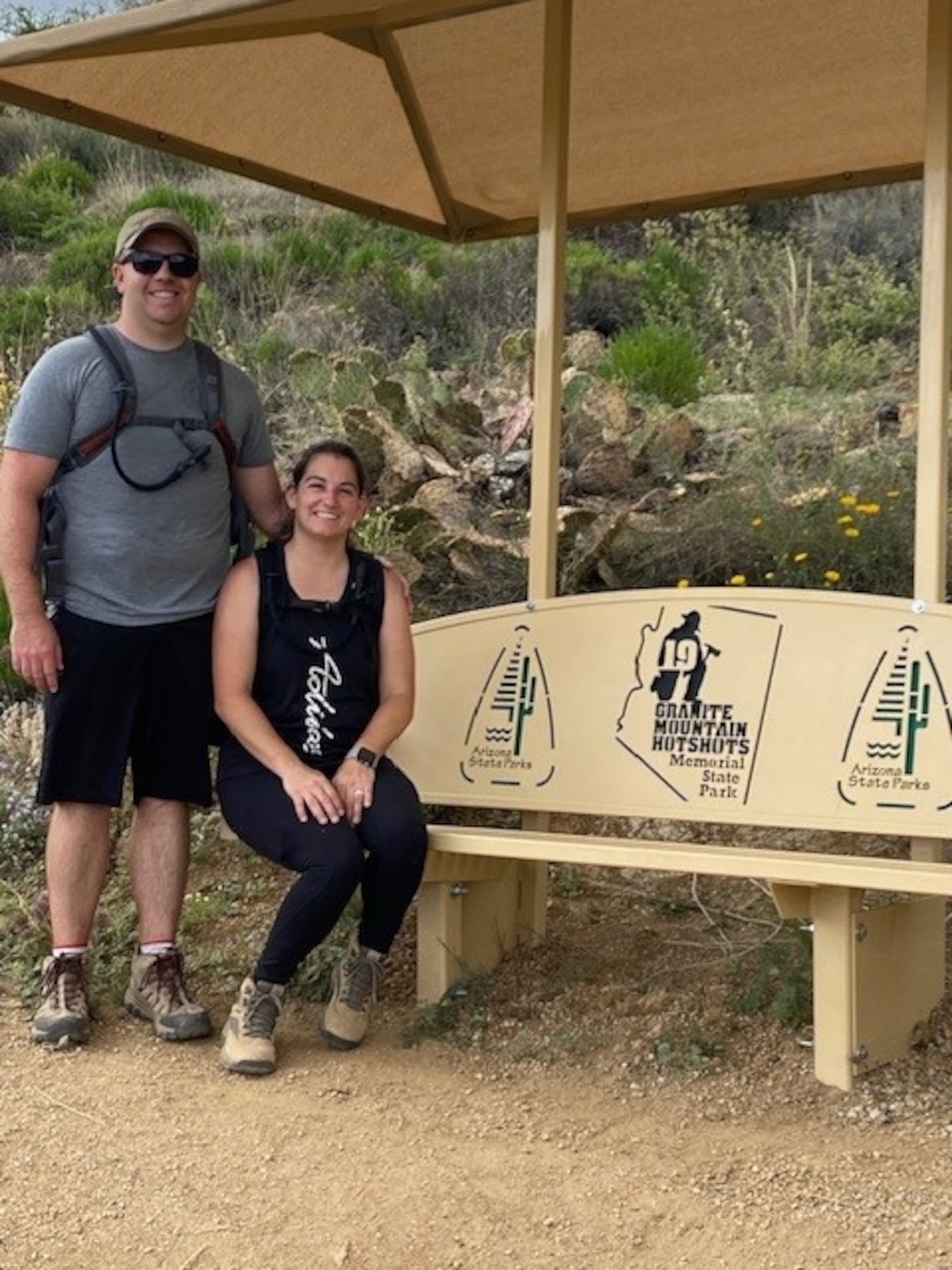 U.S. Air Force Capt. Mike Stockwell (left) and his wife Amanda Stockwell (right) pose at the Granite Mountain Hotshots Memorial State Park, June, 2023.