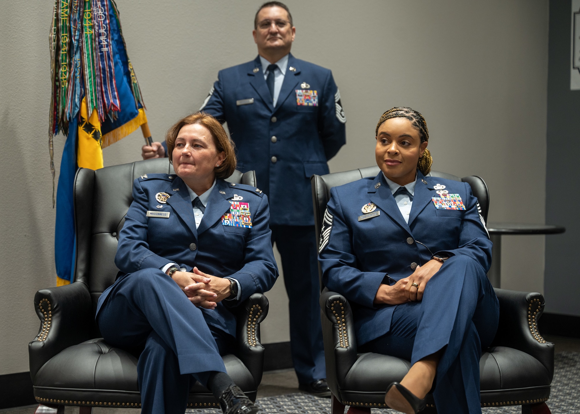 U.S. Air Force Col. Angelina Maguinness (left), 17th Training Wing commander, and Chief Master Sgt. Khamillia Washington (right), 17th Training Wing command chief, sits during the narration at the Assumption of Responsibility Ceremony at Goodfellow Air Force Base, Texas, July 24, 2023. The rank of chief master sergeant is distinguished with a star between the upper and lower chevrons. (U.S. Air Force photo by Airman 1st Class Evelyn D'Errico)
