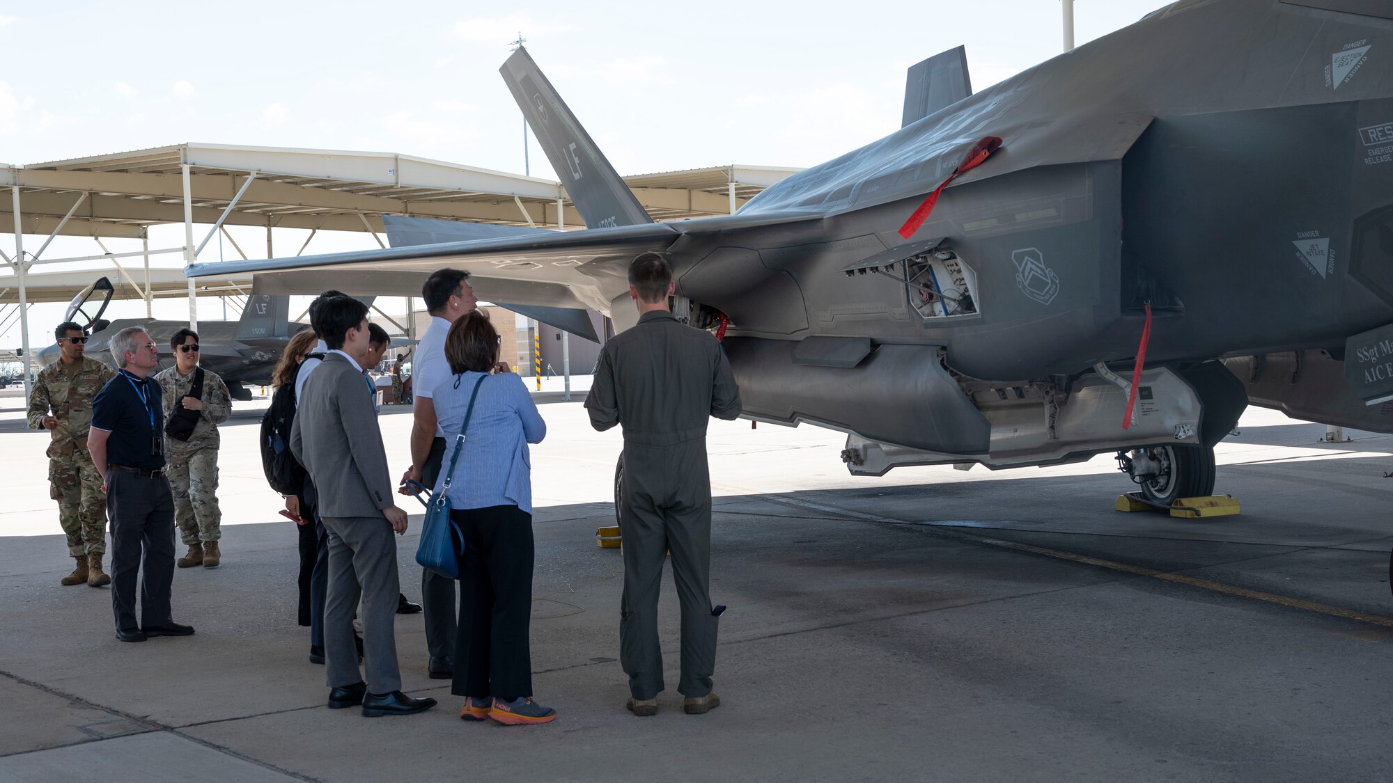 U.S. Air Force Capt. Matthew Stopka, 63rd Fighter Squadron instructor pilot, briefs Japanese civic leaders on the F-35A Lightning II at Luke Air Force Base, Arizona, on Aug. 2, 2023