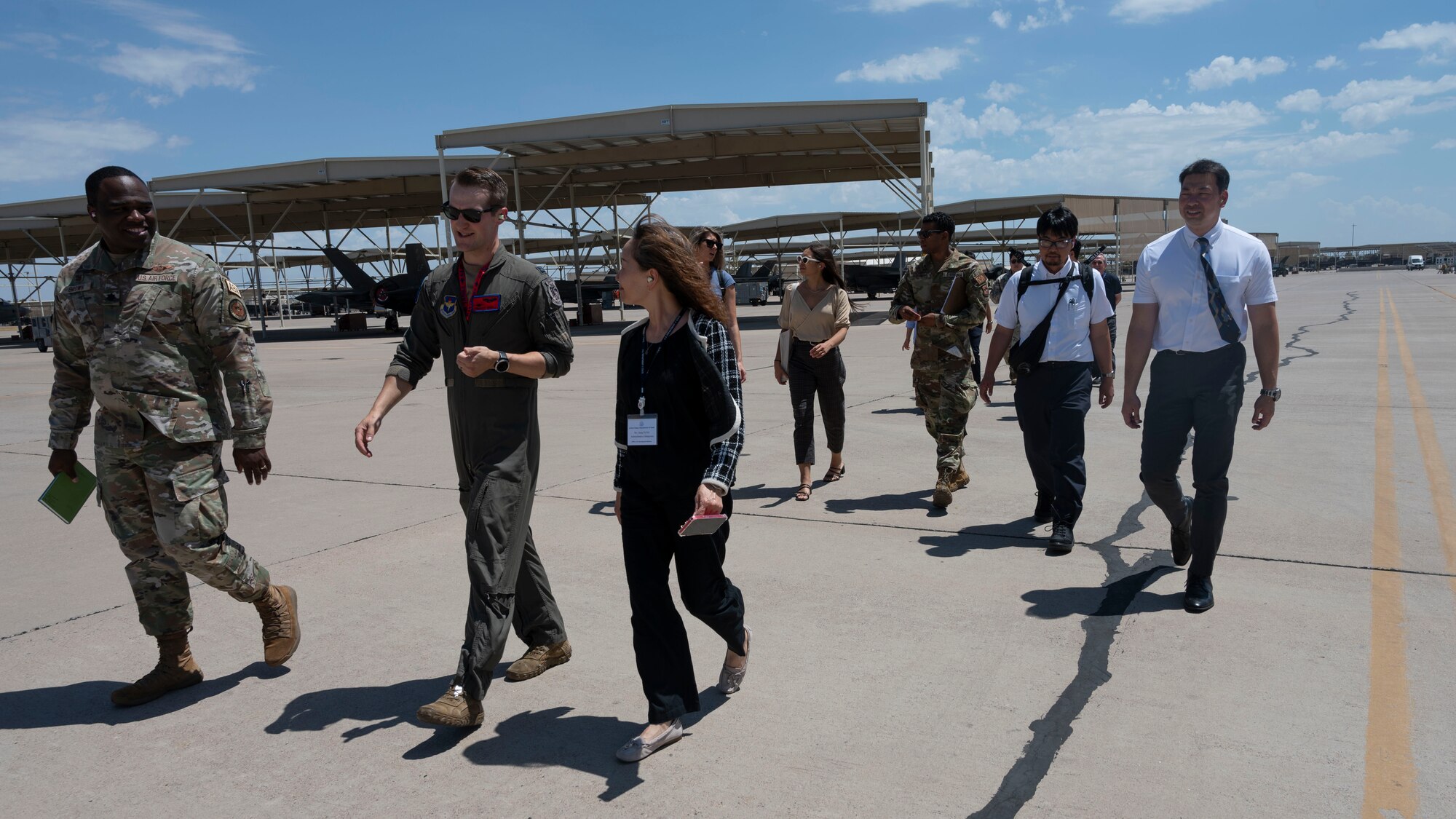 56th Fighter Wing personnel and Japanese civic leaders part of the U.S. Department of State’s International Visitor Leadership Program walk on the flightline at Luke Air Force Base, Arizona, on Aug. 2, 2023.