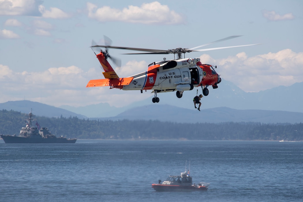 230801-N-YF131-1227 SEATTLE (Aug. 1, 2023) An MH-60T Jayhawk helicopter lifts Aviation Survival Technician 2nd Class Jon Clairdge during a search-and-rescue demonstration held during Seattle Fleet Week, Aug. 1, 2023. Seattle Fleet Week is a time-honored celebration of the sea services and provides an opportunity for the citizens of Washington to meet Sailors, Marines and Coast Guardsmen, as well as witness firsthand the latest capabilities of today’s U.S. and Canadian maritime services. (U.S. Navy photo by Mass Communication Specialist 2nd Class Madison Cassidy)