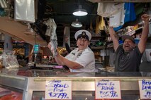 230802-N-YF131-1056 SEATTLE (Aug. 2, 2023) Chief Mass Communication Specialist Gretchen Albrecht, from Chino Hills, Calif., catches fish with Sailors at Pike Place Market during Seattle Fleet Week, Aug. 2, 2023. Seattle Fleet Week is a time-honored celebration of the sea services and provides an opportunity for the citizens of Washington to meet Sailors, Marines and Coast Guardsmen, as well as witness firsthand the latest capabilities of today’s U.S. and Canadian maritime services. (U.S. Navy photo by Mass Communication Specialist 2nd Class Madison Cassidy)