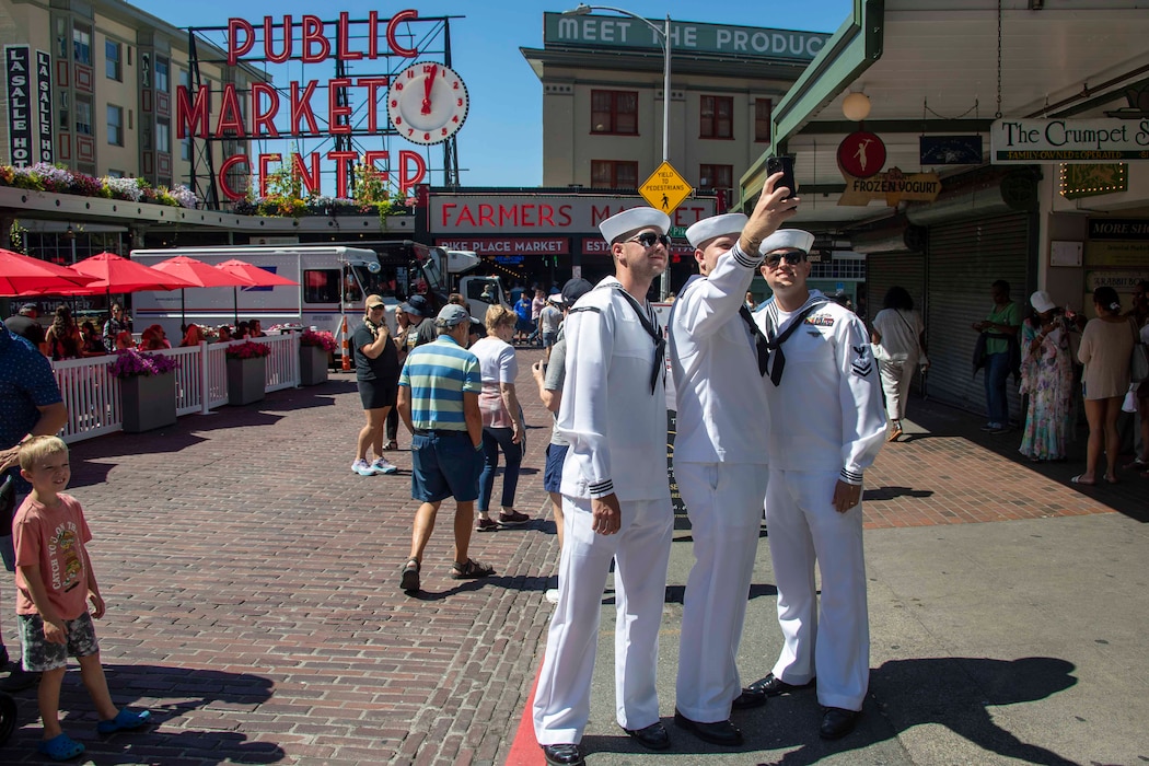 230802-N-YF131-1118 SEATTLE (Aug. 2, 2023) Sailors, assigned to the Arleigh Burke-class guided missile destroyer USS Barry (DDG 52) pose for a selfie at Pike Place Market during Seattle Fleet Week, Aug. 2, 2023. Seattle Fleet Week is a time-honored celebration of the sea services and provides an opportunity for the citizens of Washington to meet Sailors, Marines and Coast Guardsmen, as well as witness firsthand the latest capabilities of today’s U.S. and Canadian maritime services. (U.S. Navy photo by Mass Communication Specialist 2nd Class Madison Cassidy)