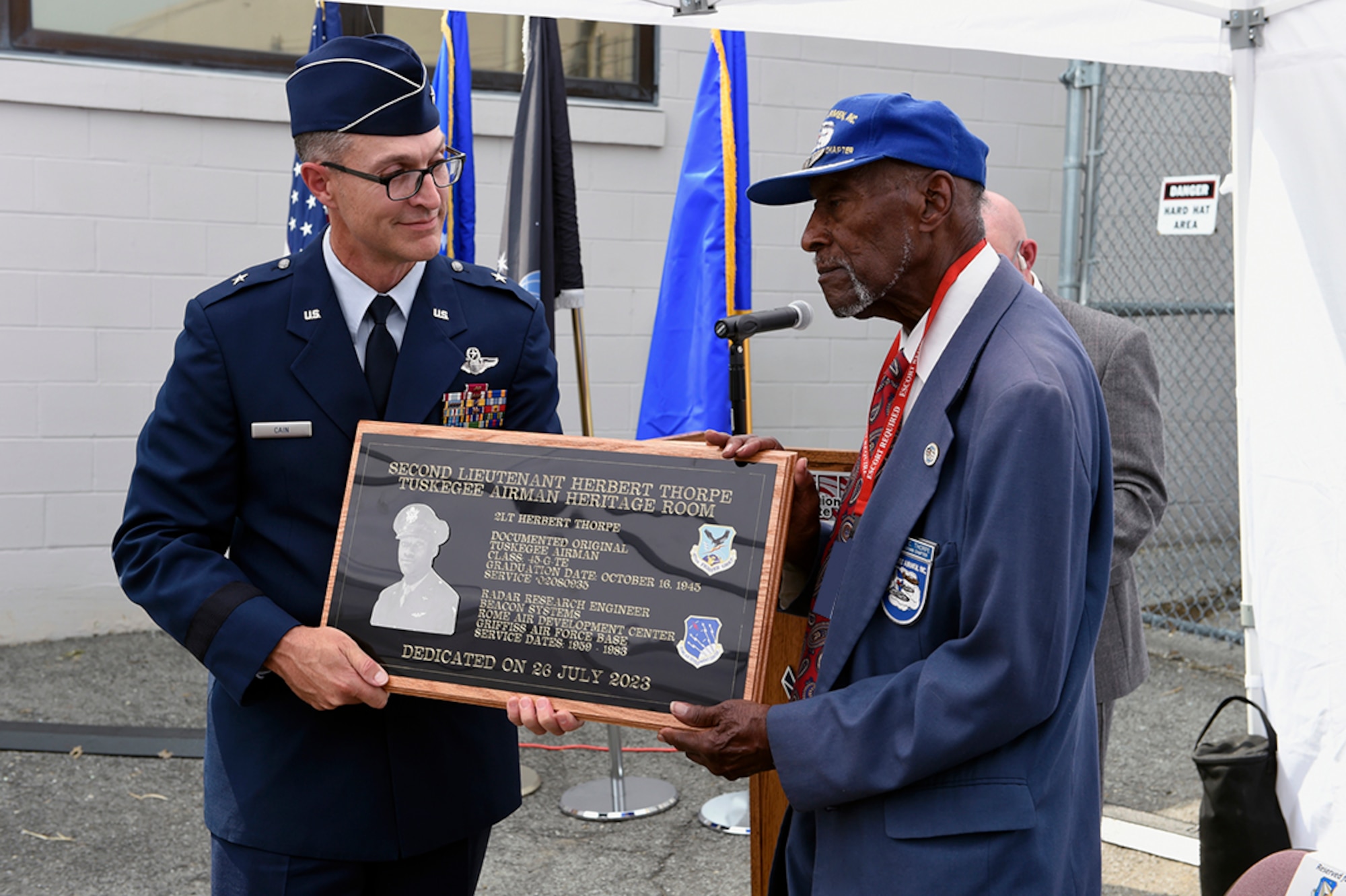 Brig. Gen. Scott Cain presents a dedication plaque, to 2nd Lt. Herbert Thorpe, a Tuskegee Airman and former electrical engineer July 27, 2023. A room at the AFRL Information Directorate in Rome, New York was dedicated in Thorpe’s honor for his service to the nation and to the Air Force Research Laboratory. (U.S. Air Force photo/Albert Santacroce)