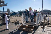 SEATTLE (Aug. 3, 2023) Civilians step aboard the Arleigh Burke-class guided missile destroyer USS Barry (DDG 52) for open ship tours during Seattle Fleet Week, Aug. 3, 2023. Seattle Fleet Week is a time-honored celebration of the sea services and provides an opportunity for the citizens of Washington to meet Sailors, Marines and Coast Guardsmen, as well as witness firsthand the latest capabilities of today’s U.S. and Canadian maritime services. (U.S. Navy photo by Mass Communication Specialist 2nd Class Madison Cassidy)