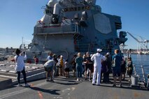 230803-N-YF131-1030 SEATTLE (Aug. 3, 2023) Electronic Technician 1st Class Jean Paulynice, from Brooklyn, assigned to the Arleigh Burke-class guided missile destroyer USS Barry (DDG 52) leads ship tours during Seattle Fleet Week, Aug. 3, 2023. Seattle Fleet Week is a time-honored celebration of the sea services and provides an opportunity for the citizens of Washington to meet Sailors, Marines and Coast Guardsmen, as well as witness firsthand the latest capabilities of today’s U.S. and Canadian maritime services. (U.S. Navy photo by Mass Communication Specialist 2nd Class Madison Cassidy)