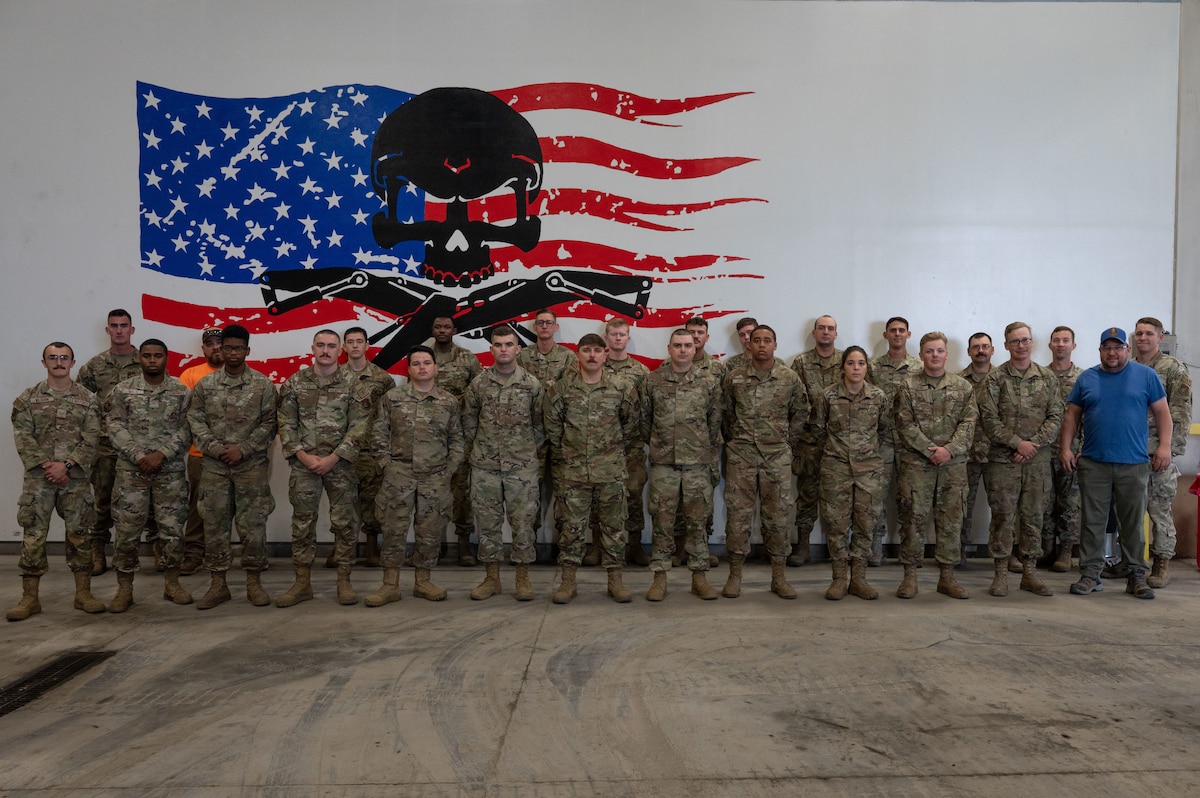 U.S. Airmen and personnel assigned to the 354th Civil Engineer Squadron pose for a group photo on Eielson Air Force Base, Alaska, Aug. 2, 2023.
