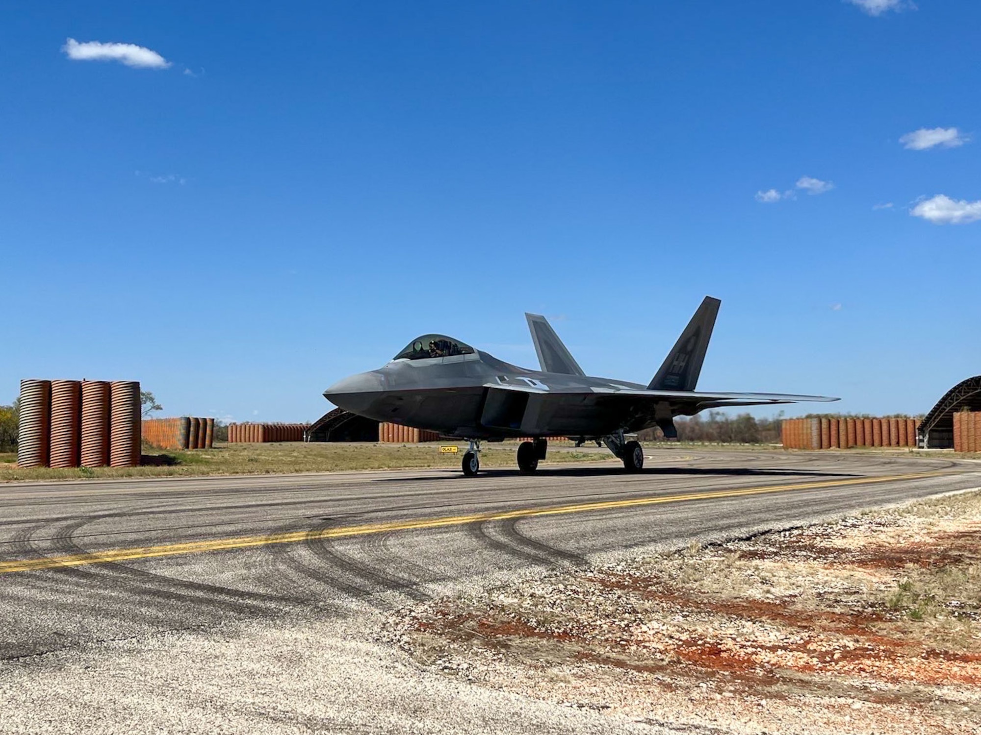 A U.S. Air Force F-22 Raptor from the 199th Air Expeditionary Squadron, known as the Hawaiian Raptors Squadron, comprised of the 19th and the 199th Fighter Squadrons, taxis during Talisman Sabre 23 at Royal Australian Air Force Base Curtin, Western Australia, Australia, Aug. 2, 2023. Talisman Sabre is the U.S.’s largest bilateral exercise in Australia that demonstrates the capability to rapidly deploy and operate to accomplish a wide range of missions alongside joint and allied partners to ensure a free and open Indo-Pacific. (U.S. Air Force photo by Senior Airman Jai Kurihara-Alfonso)
