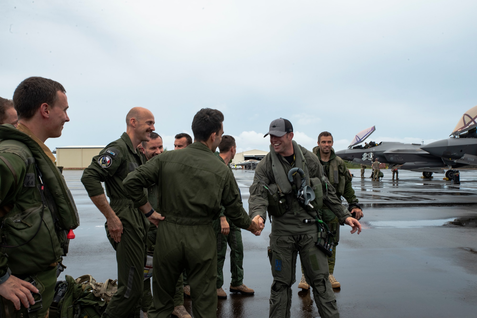U.S. Air Force F-35A Lighting II pilots from the 419th Fighter Wing greet French Air and Space Force Dassault Rafale pilots after landing together at Roman Tmetuchl International Airport in Koror, Palau, July 7, 2023. The multi-national team arrived in Palau for Northern Edge 23-2, a multilateral exercise that enhances interoperability and cooperation and tests defensive readiness in the Indo-Pacific region. (U.S. Air Force photo by 1st Lt. Michelle Chang)