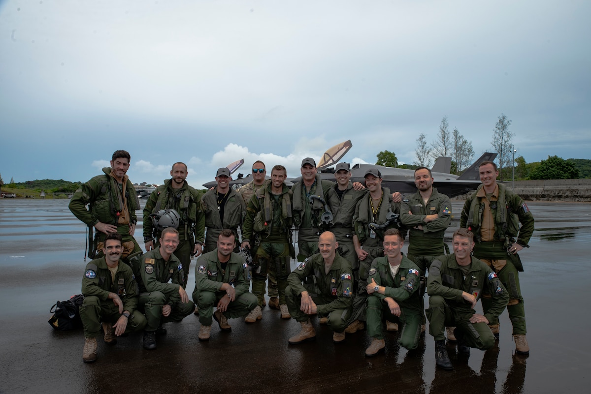 U.S. Air Force F-35A Lighting II pilots from the 419th Fighter Wing, and French Air and Space Force Dassault Rafale pilots pose for a photo at Roman Tmetuchl International Airport in Koror, Palau, July 7, 2023. The multi-national team arrived in Palau for Northern Edge 23-2, a multilateral exercise that enhances interoperability and cooperation and tests defensive readiness in the Indo-Pacific region. (U.S. Air Force photo by 1st Lt. Michelle Chang)