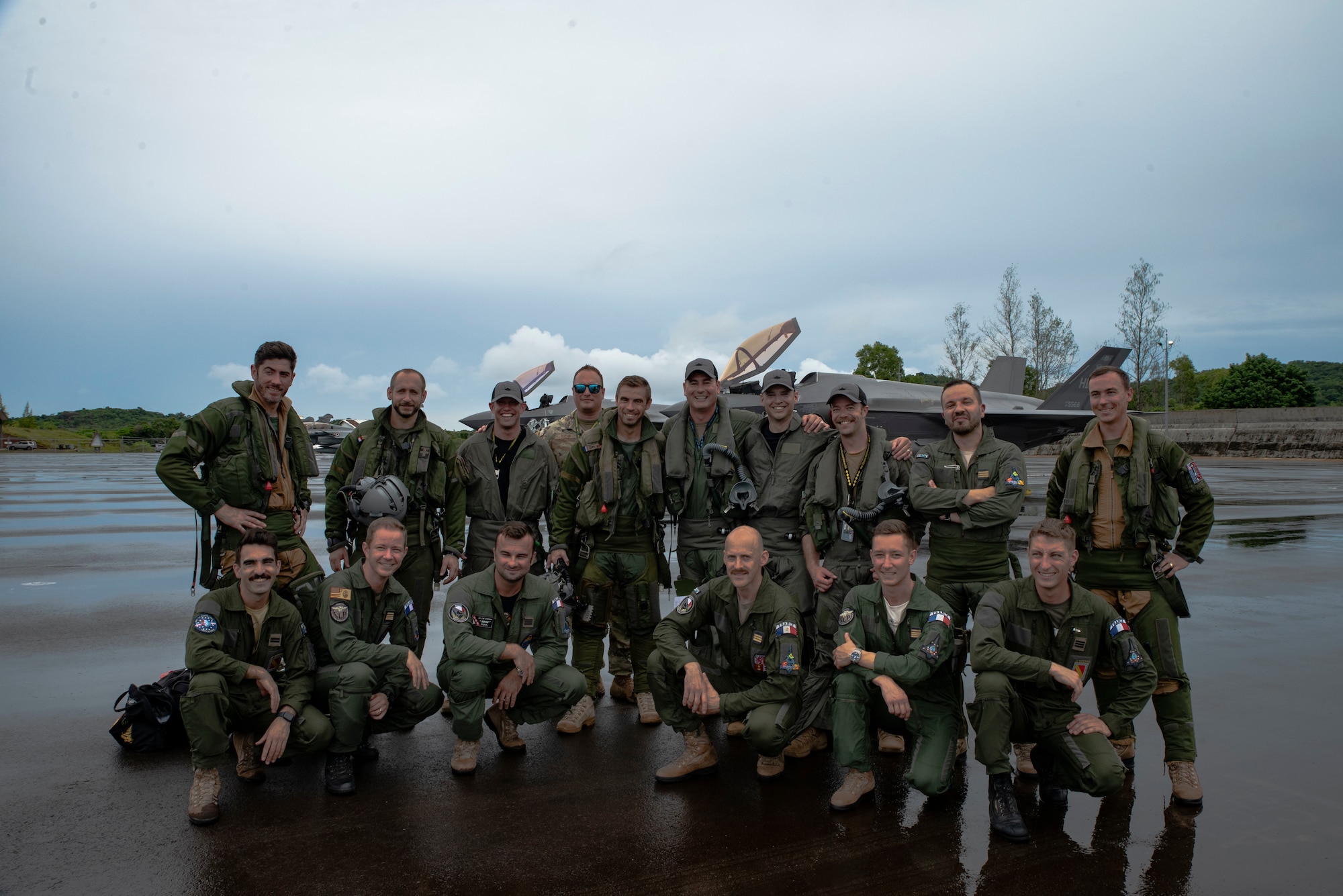 U.S. Air Force F-35A Lighting II pilots from the 419th Fighter Wing, and French Air and Space Force Dassault Rafale pilots pose for a photo at Roman Tmetuchl International Airport in Koror, Palau, July 7, 2023. The multi-national team arrived in Palau for Northern Edge 23-2, a multilateral exercise that enhances interoperability and cooperation and tests defensive readiness in the Indo-Pacific region. (U.S. Air Force photo by 1st Lt. Michelle Chang)