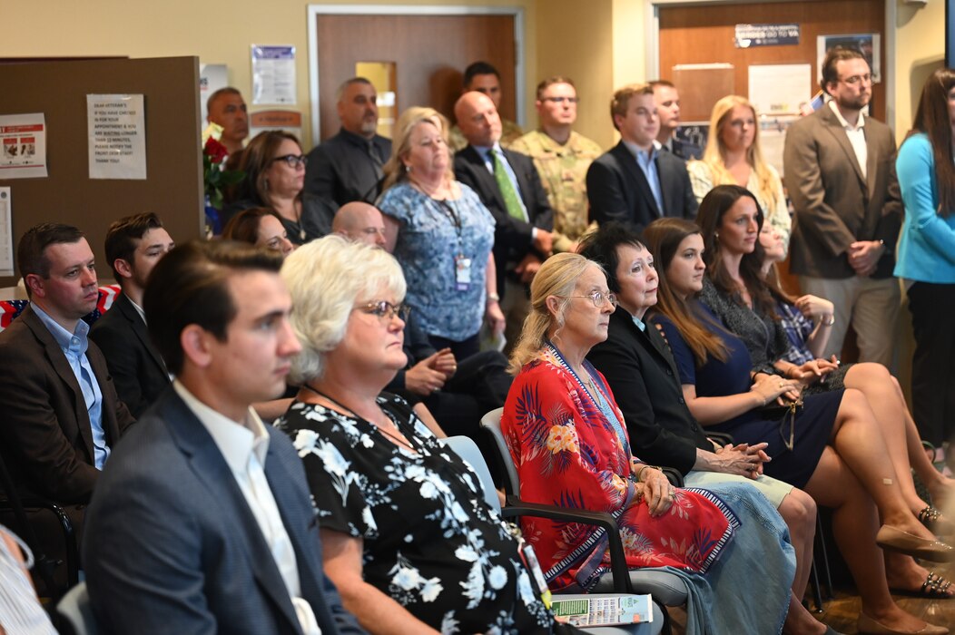 Event attendees listen to remarks given by U.S. Air Force Col. Angelina Maguinness, 17th Training Wing commander, during the Veteran Affairs Clinic renaming ceremony, San Angelo, Texas, July 31, 2023. The crowd was made up of community members, service members, and family of the Powells. Many of the attendees were directly impacted by either Charles or JoAnne Powell in either their professional or personal endeavors. (U.S. Air Force photo by Airman 1st Class Madison Collier)