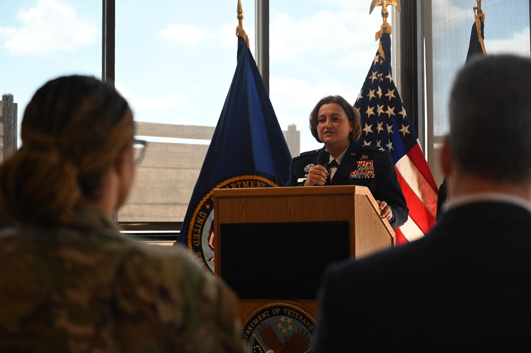 U.S. Air Force Col. Angelina Maguinness, 17th Training Wing commander, delivers remarks on the impact Charles and JoAnne Powell had on Goodfellow Air Force Base and the surrounding community of San Angelo during the Veteran Affairs Clinic renaming ceremony, San Angelo, Texas, July 31, 2023. Maguinness discussed the legacy that Charles and JoAnne Powell left behind and the importance of the renaming ceremony. “As we reflect on the legacy of the Powells, let us remember that the greatest tribute we can pay to them is to continue their mission, to continue the work they started, and to keep the flame of service burning bright within us. Let us ensure that this clinic, now bearing the Powell name, remains a beacon of hope for those who have served our nation,” said Col. Maguinness. (U.S. Air Force photo by Airman 1st Class Madison Collier)